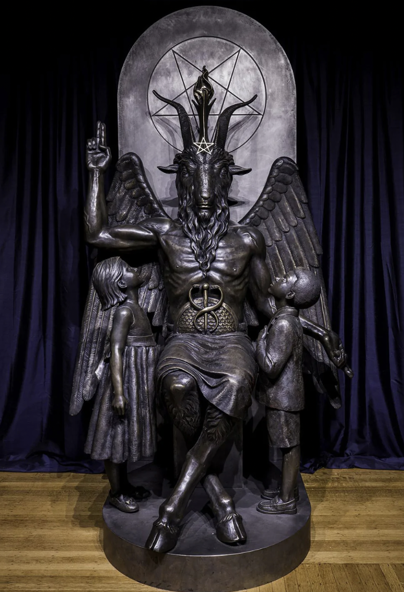 Black statue of goat-headed demon Baphomet, with two children looking adoringly up into his face