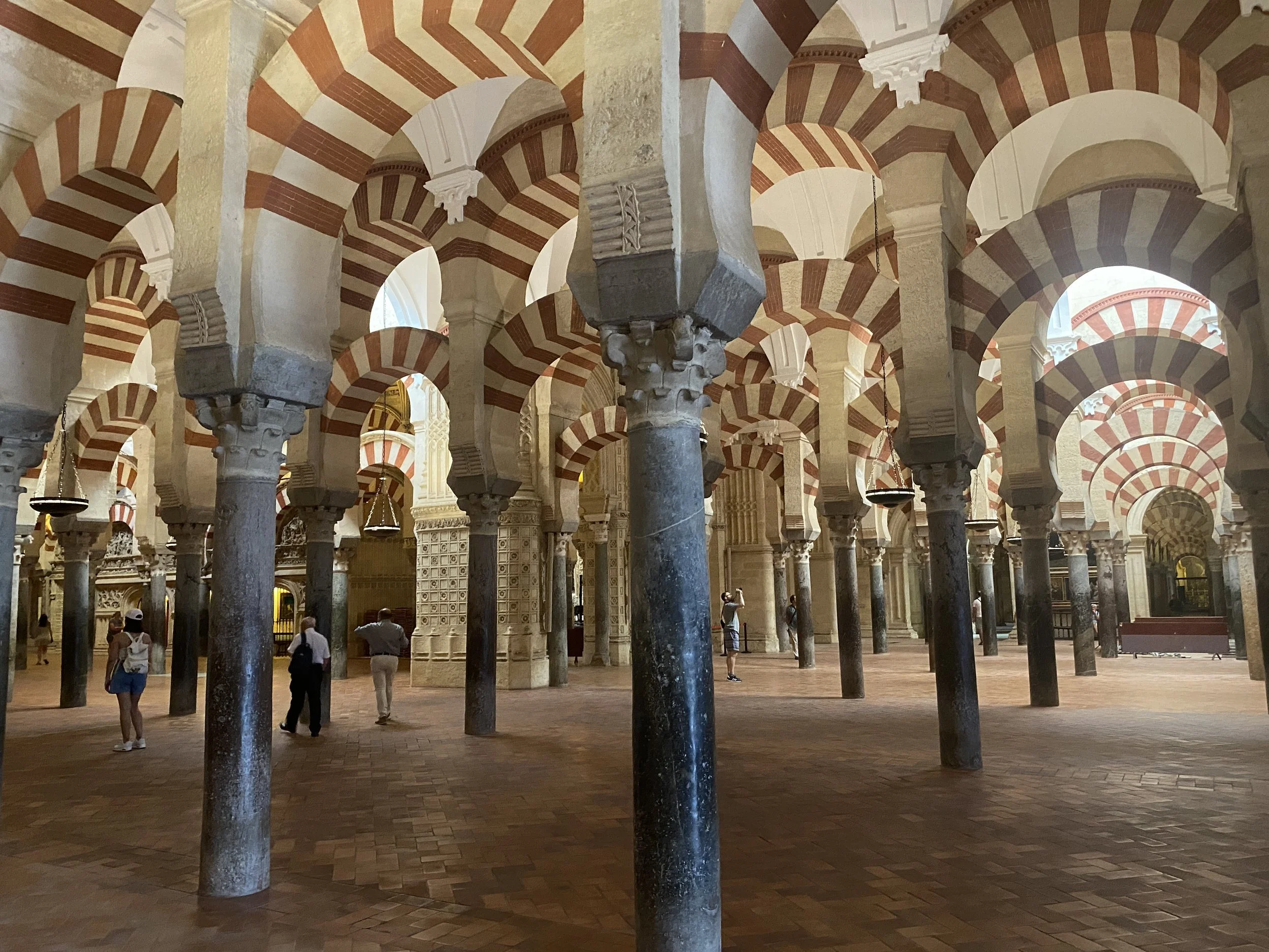 Blue marble columns support red and white striped arches that repeat in the Mezquita in Córdoba, Spain