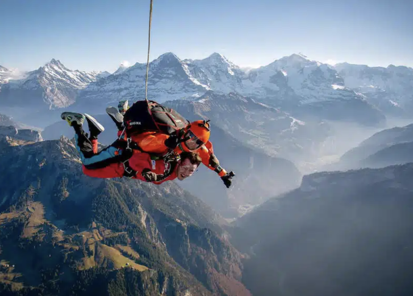 Two people skydive in the Swiss Alps