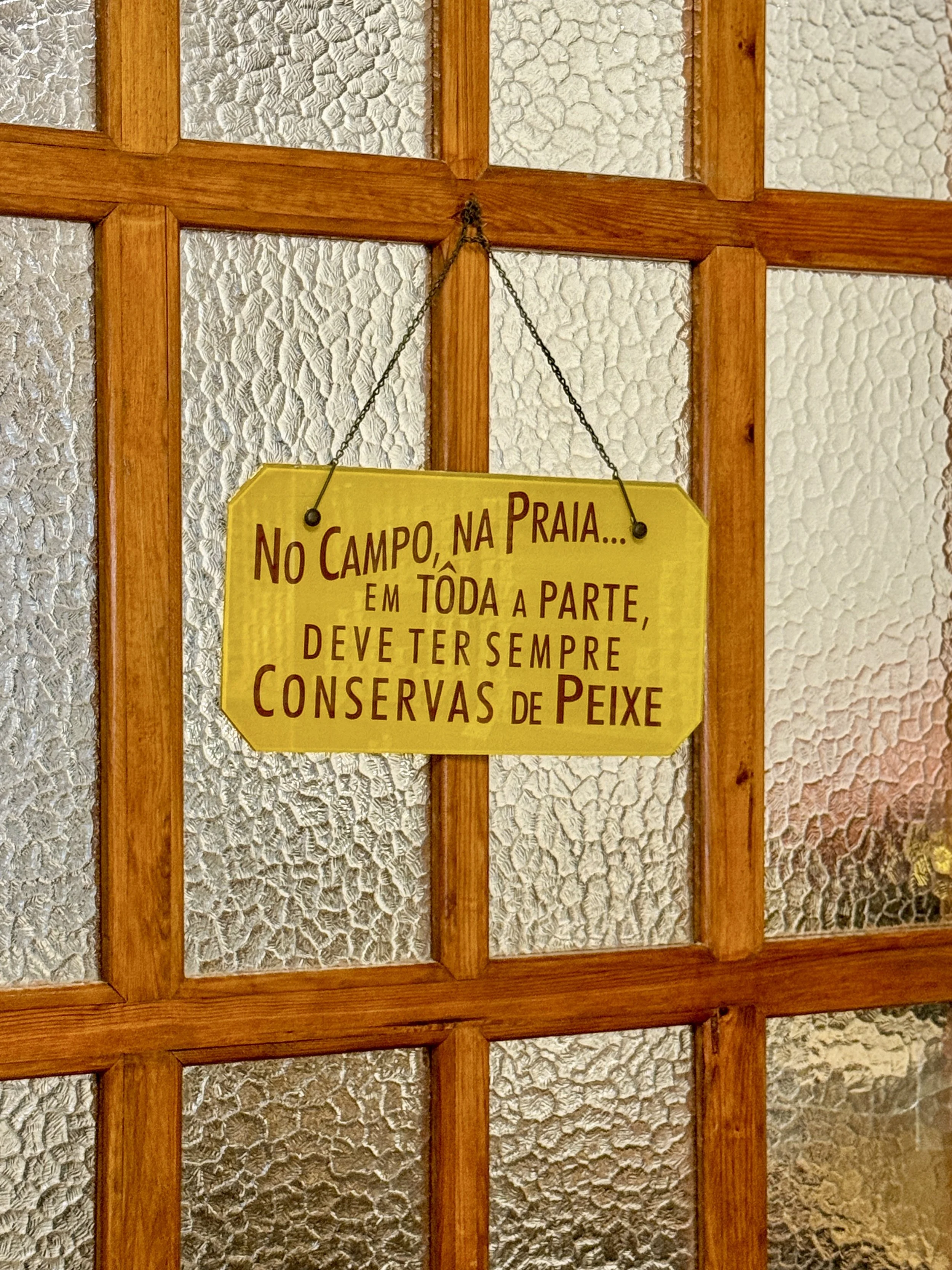 A sign at Conserveira de Lisboa reads, “In the countryside, on the beach… everywhere you should always have canned fish.”