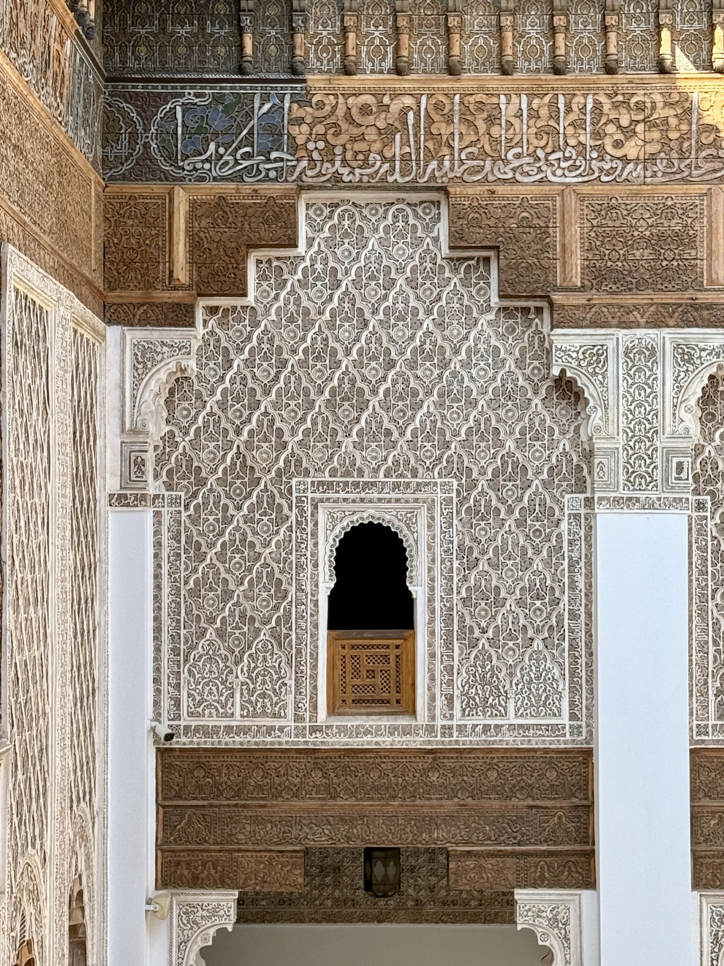 Arabic calligraphy and carved Islamic patterns in the beautiful Ben Youssef Madrasa