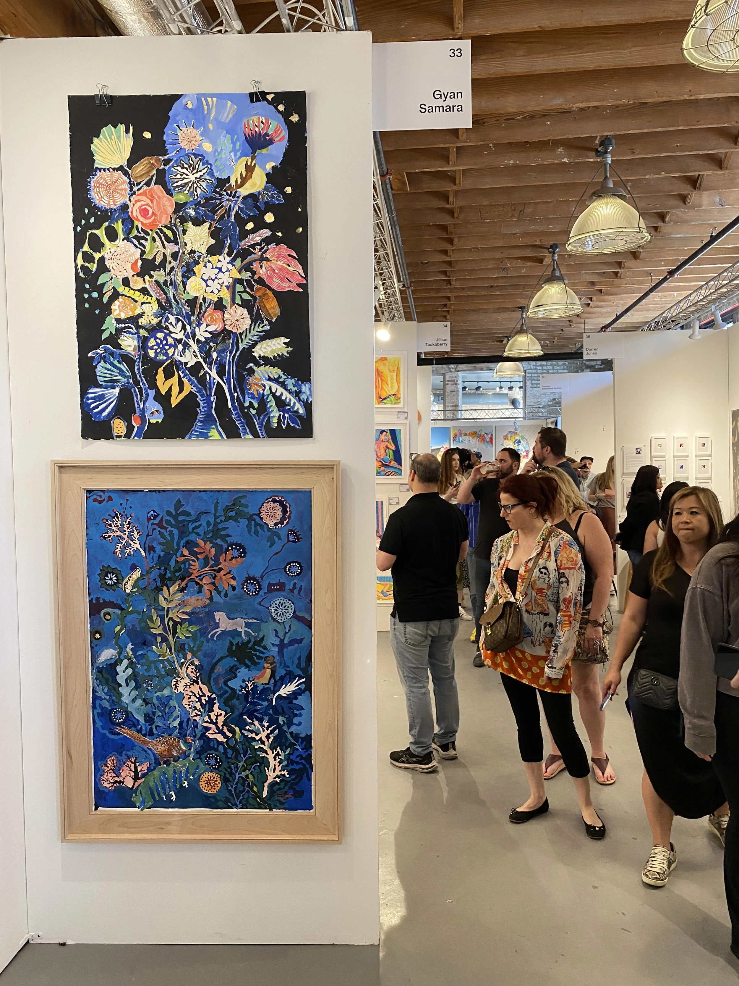 People look at the art for sale at the Other Art Fair in Chicago