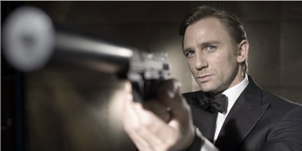 Daniel Craig, in a tux as James Bond, points a gun