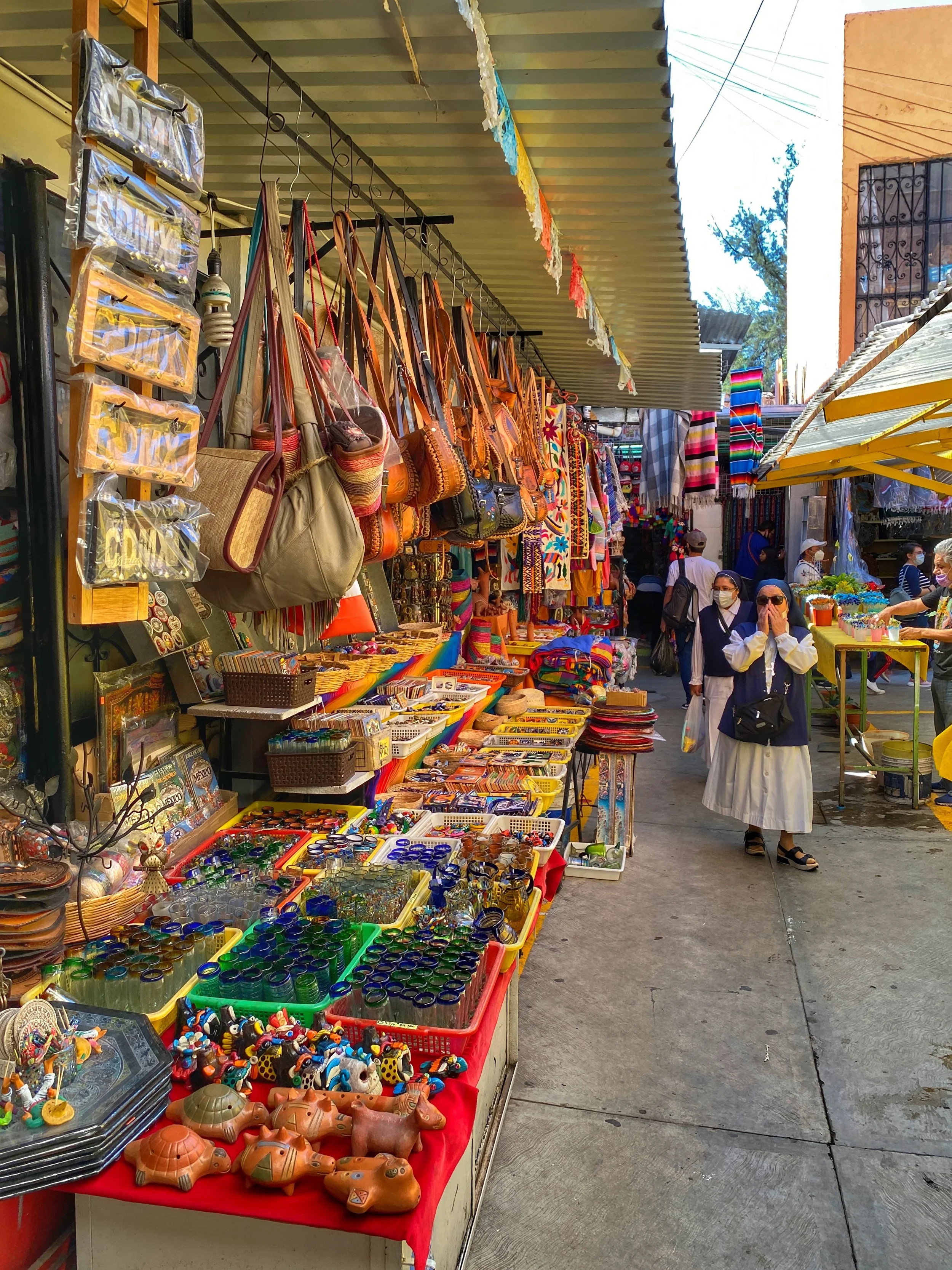 Nuns walk through the handicraft market of La Ciudadela in CDMX