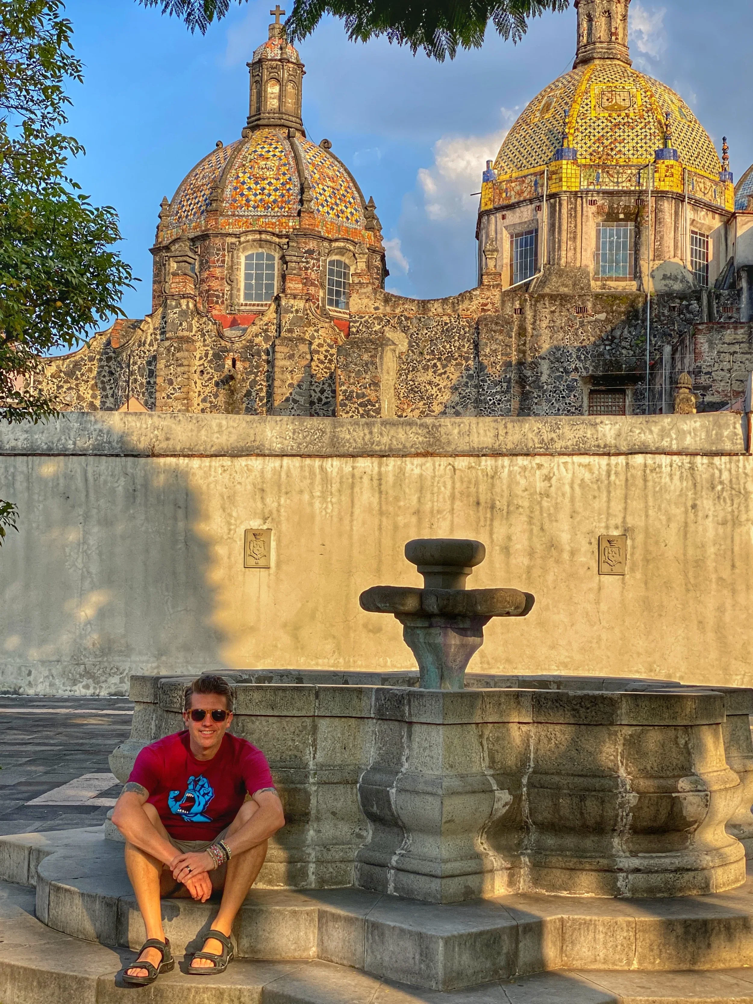 A man sits by the fountain at Nuestra Señora del Carmen in the San Angel neighborhood of CDMX