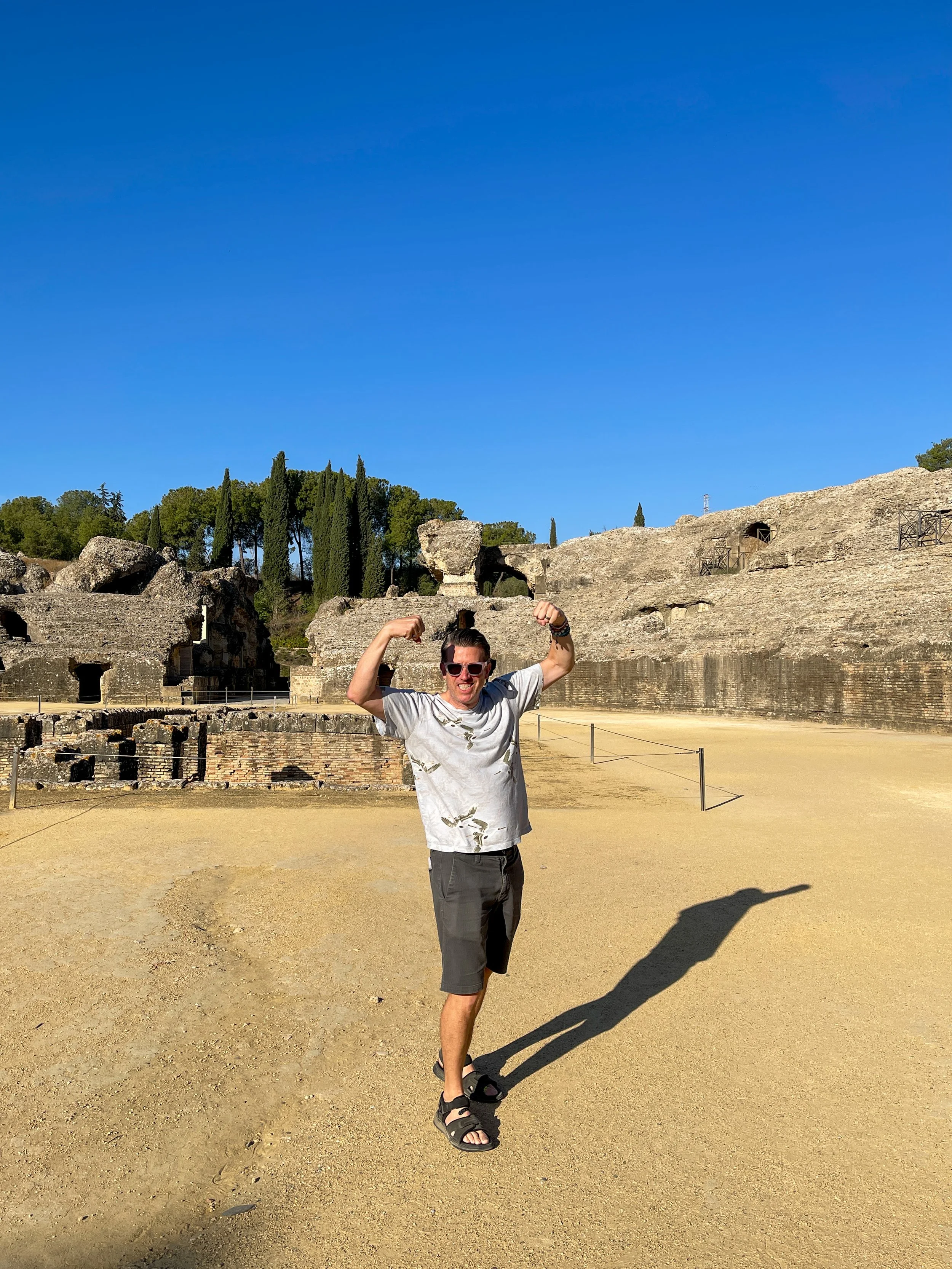 Man flexing in the amphitheater at Italica in Spain