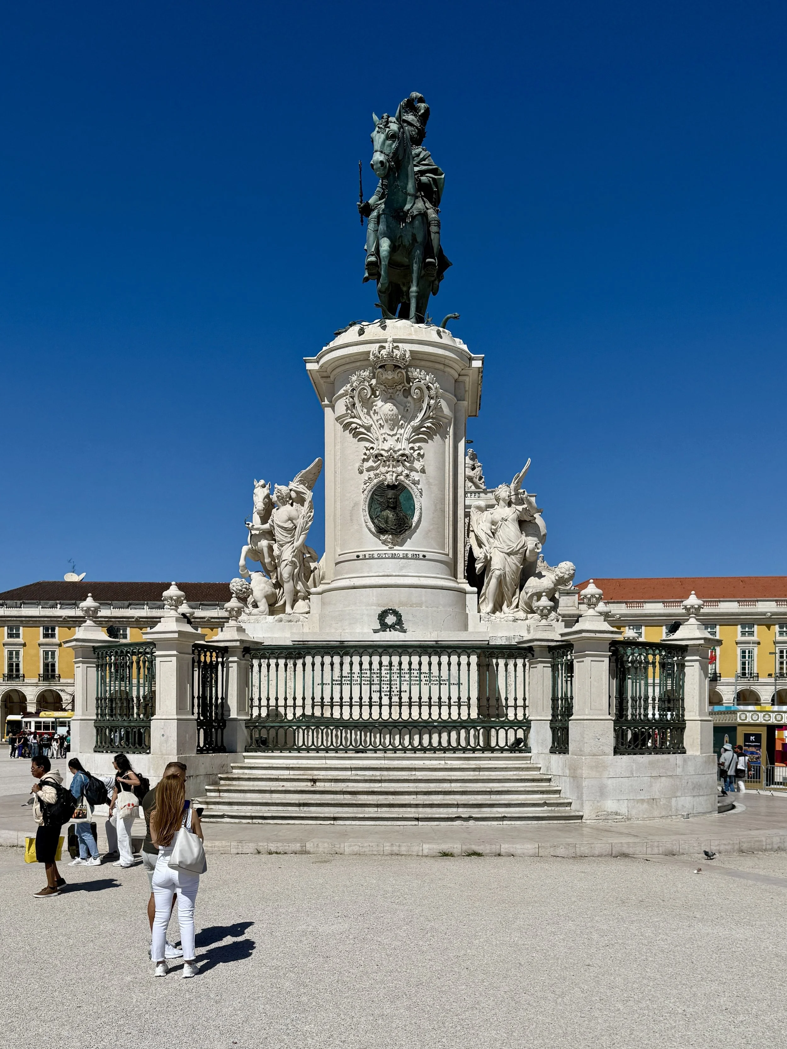 A statue of King José I surveys Praça do Comércio on horseback near the river, part of Lisbon’s grand post-1755 rebuild