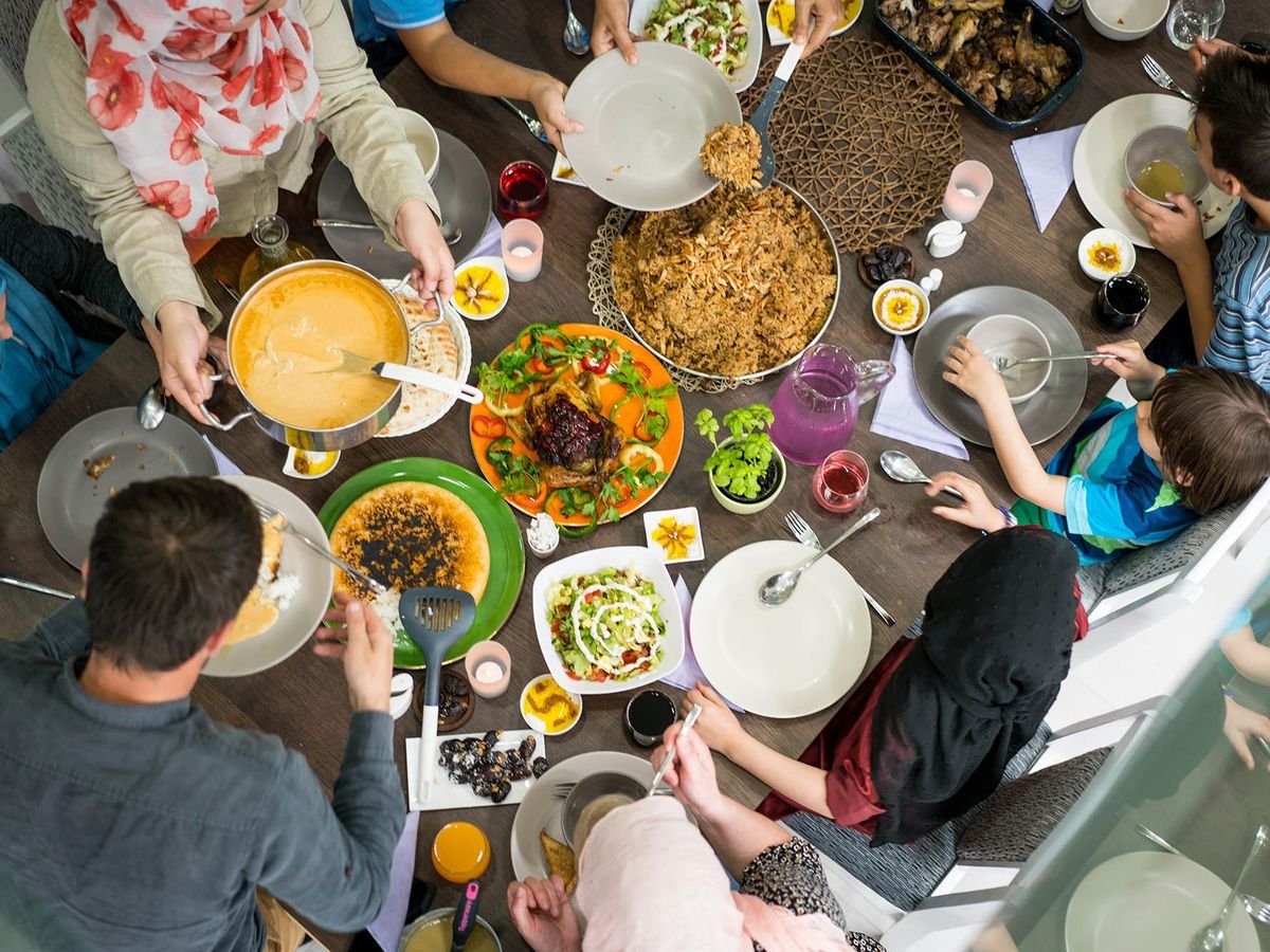 Top down photo of Muslim family having iftar with a table full of food