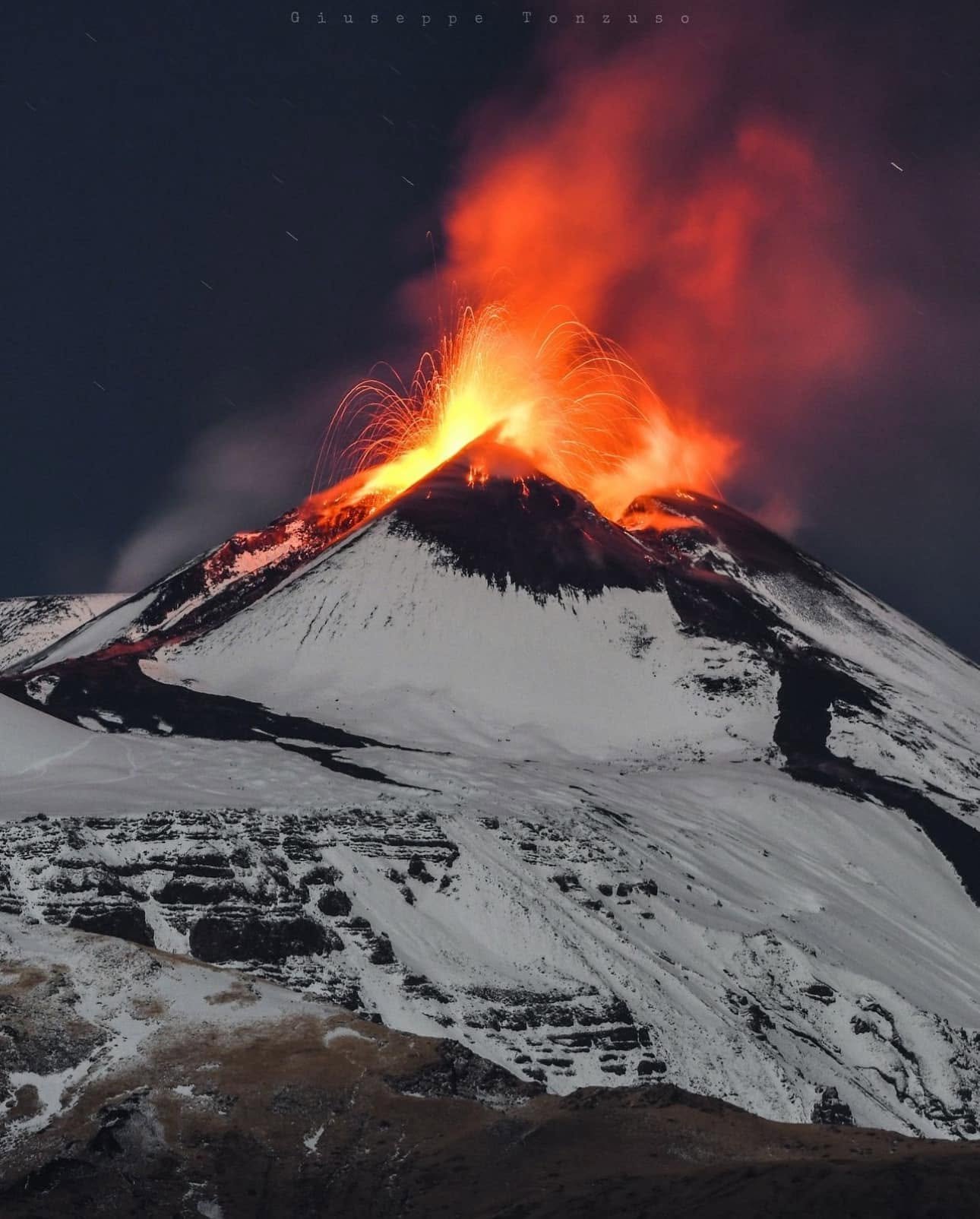 A snowy Mount Etna volcano erupts in Italy
