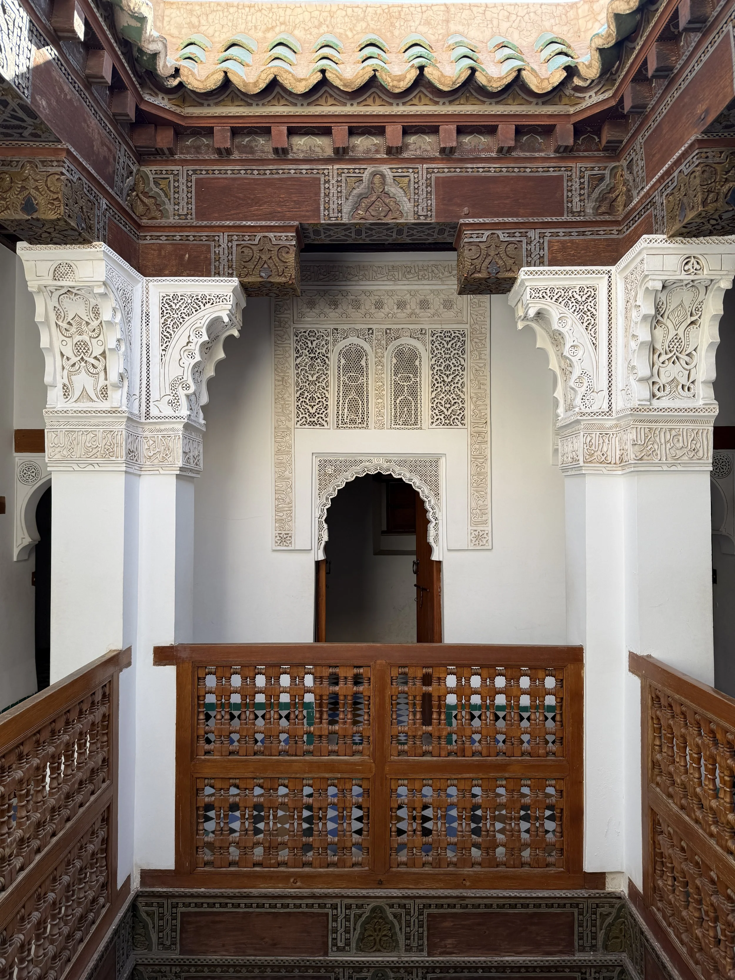 Wooden balconies in the hallways of the upstairs dormitories at Ben Youssef Madrasa
