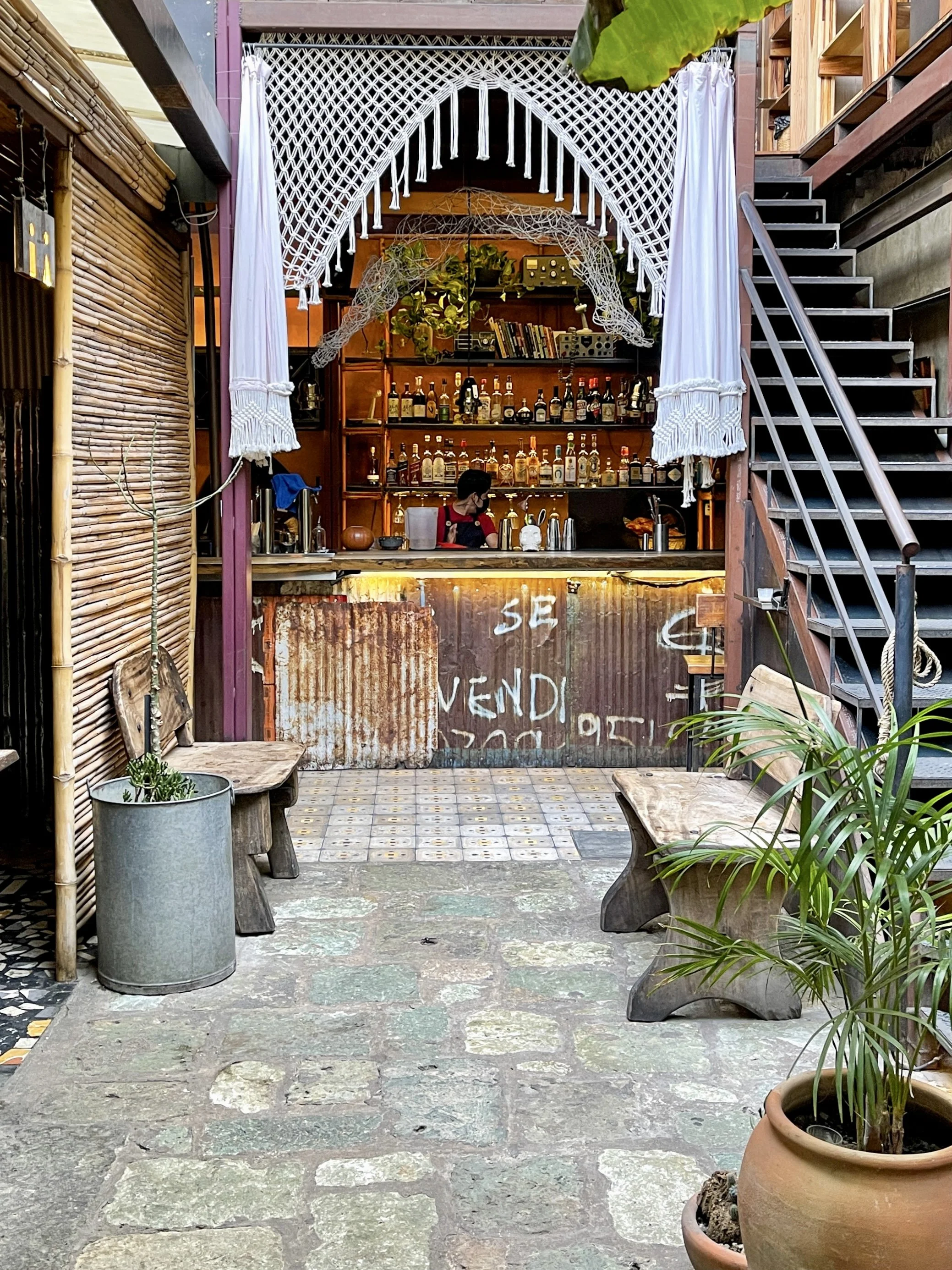White curtains and corrugated metal on the small bar at Boulenc, with bamboo screen on one side and stairwell on the other