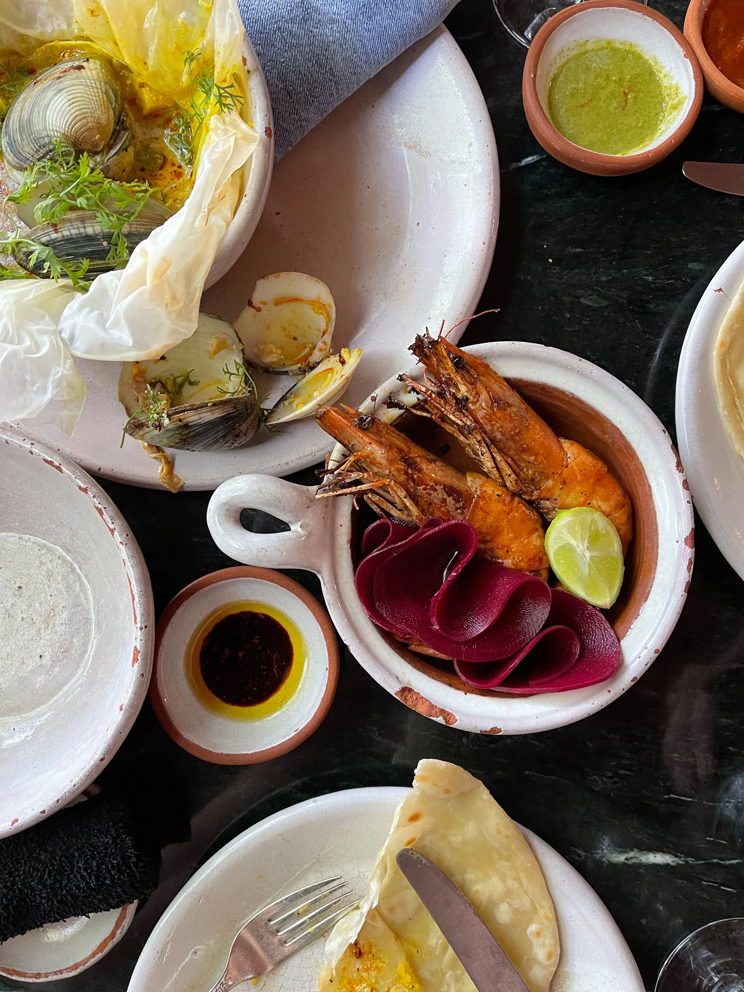 Two shrimp in a small bowl amid lunch at  Masala y Maíz in CDMX
