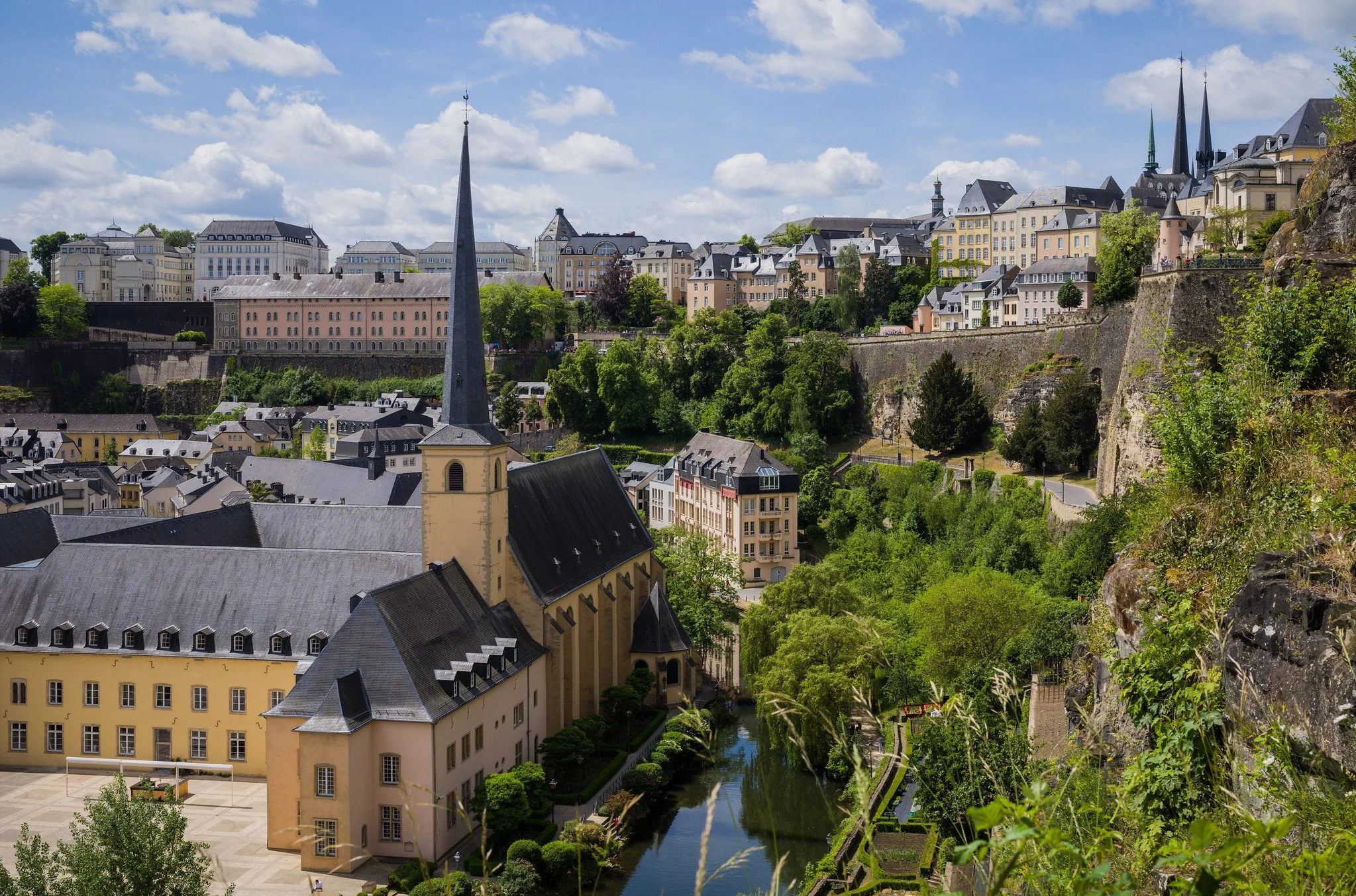 The buildings of Luxembourg City and the plant-filled remains of the fortress wall