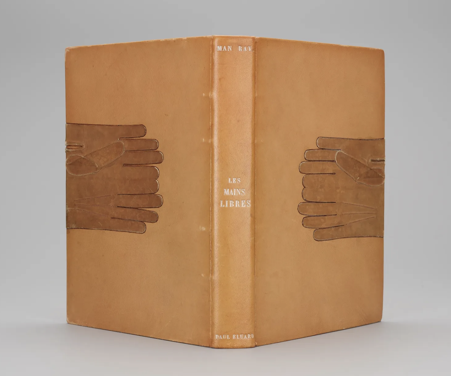 cover of Les mains libres (Free Hands) by Paul Éluard, with glove-like cutouts designed by Mary Reynolds