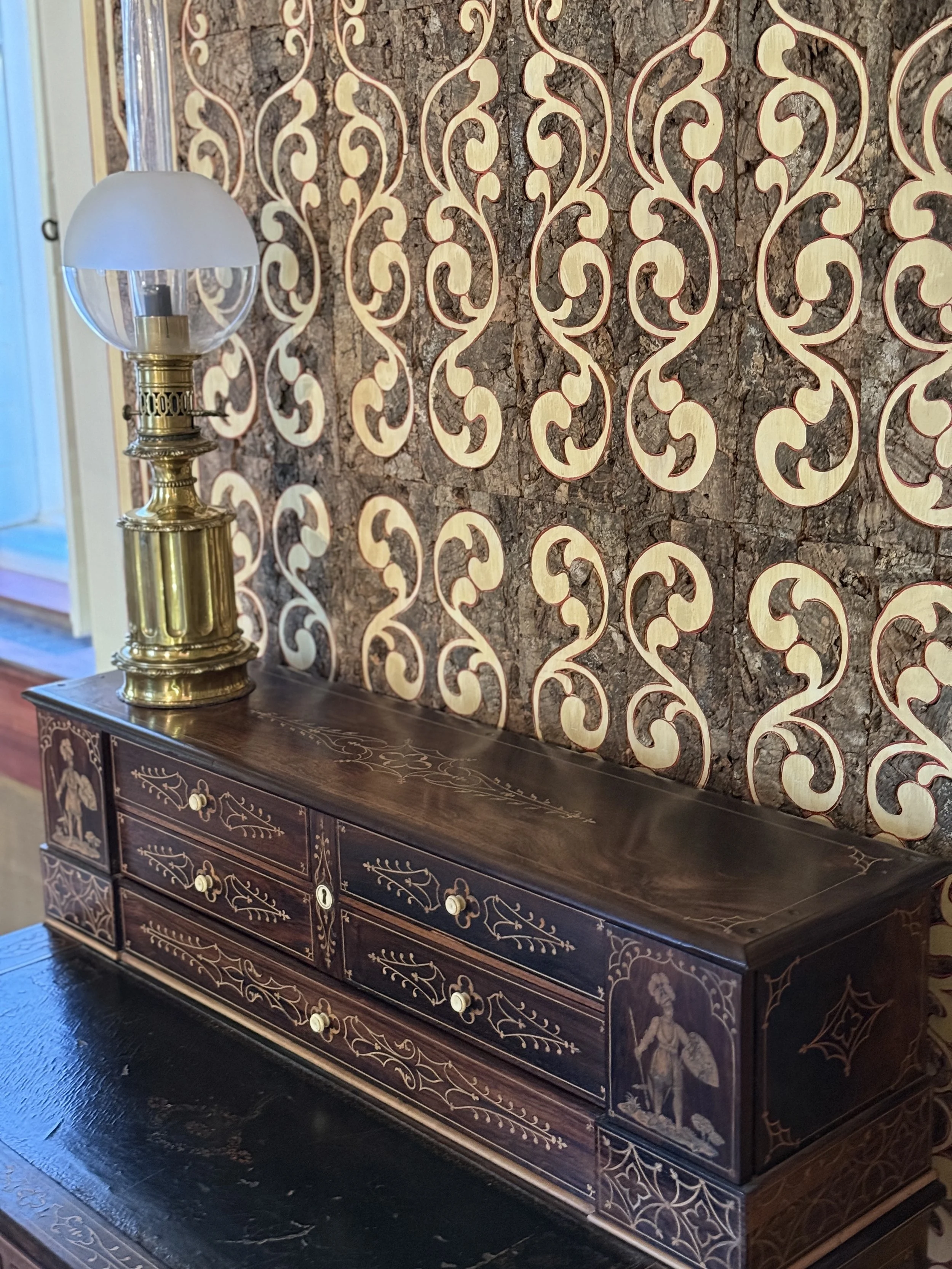 A credenza with lamp by the cork-covered wall in the dining room of the Chalet da Condessa d’Edla in Sintra, Portugal