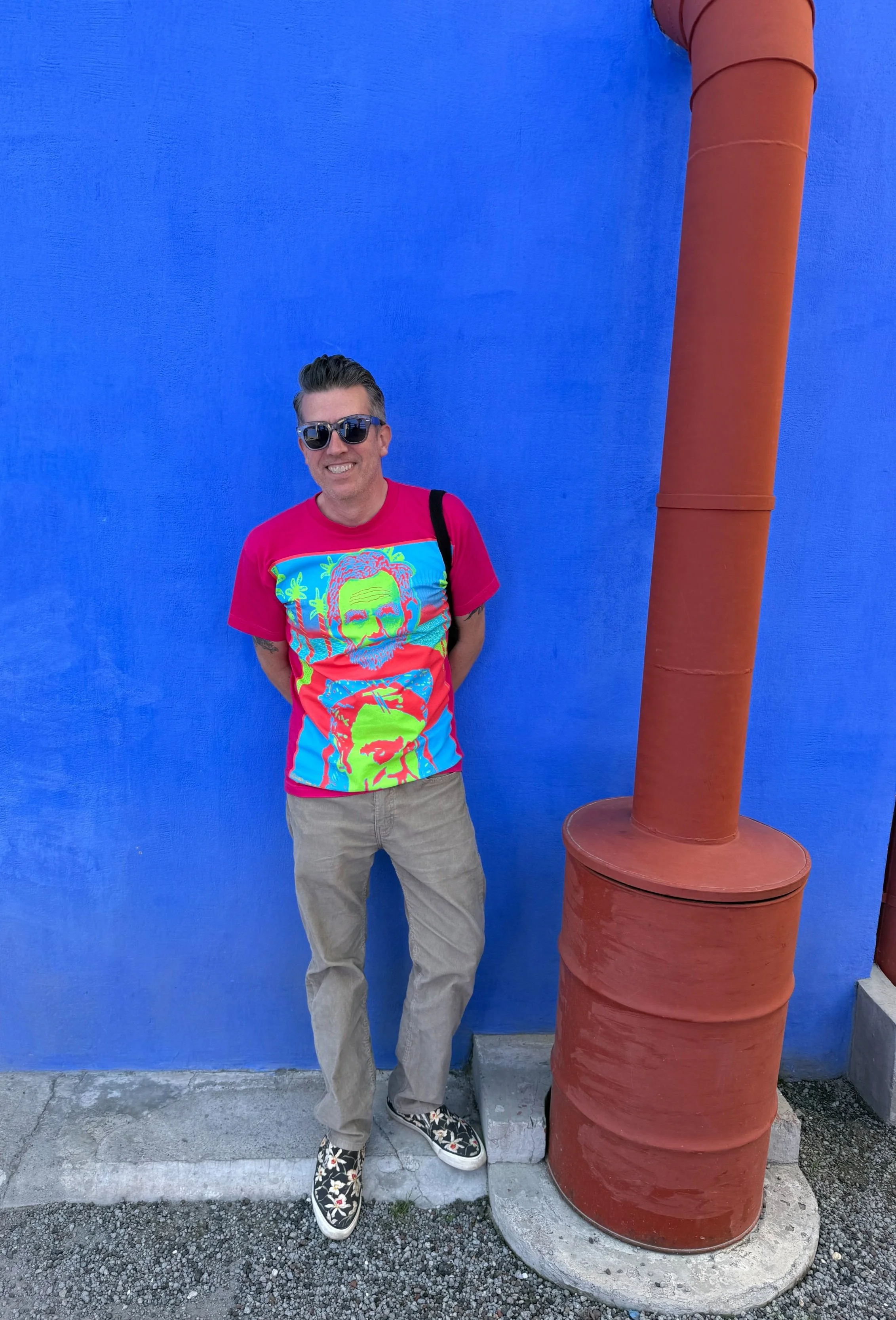 Wally leans against the blue wall of Frida's house by the kitchen garbage chute at the Museo Casa Estudio Diego Rivera y Frida Kahlo