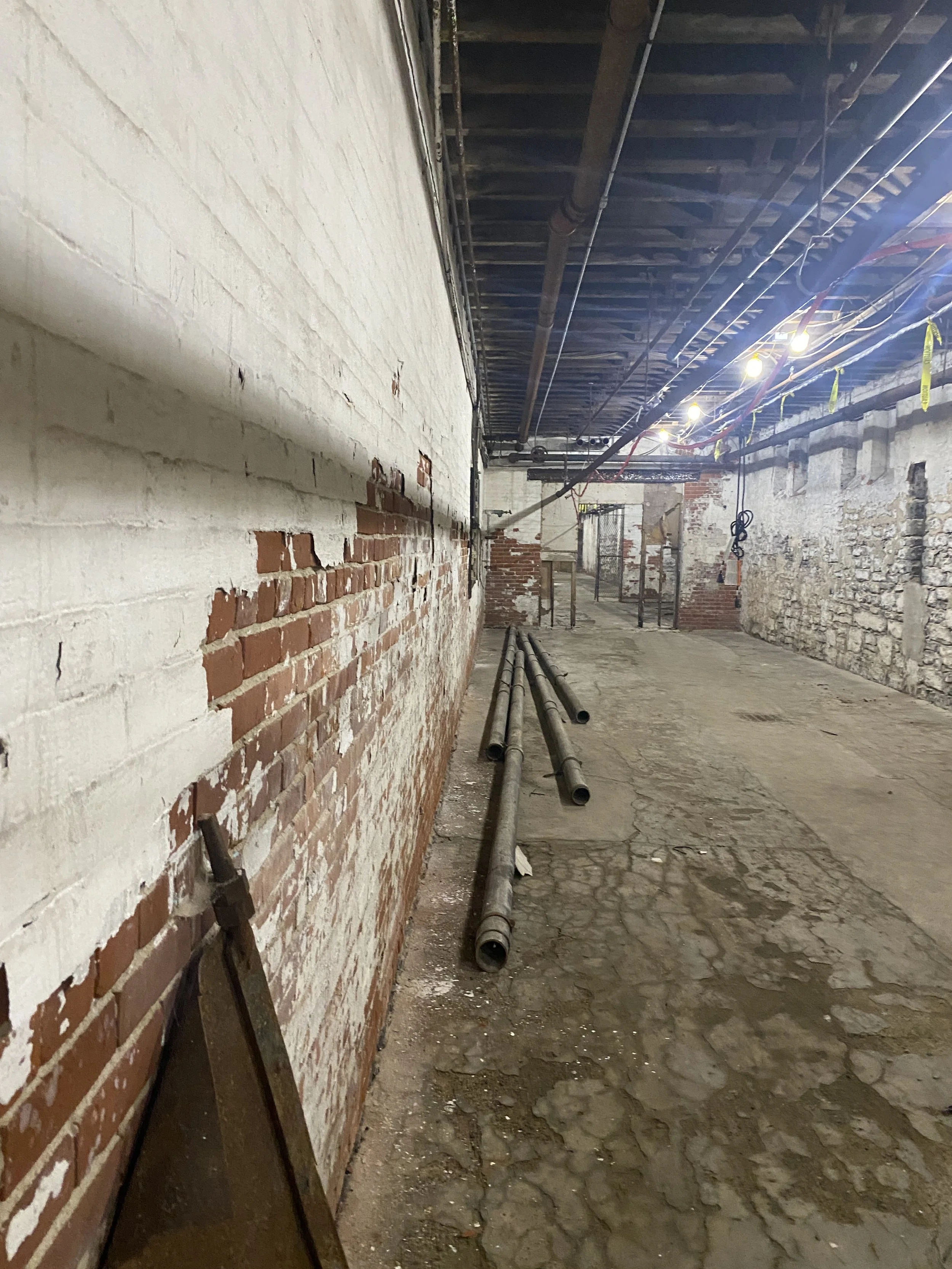 Pipes on the ground in the basement level of the the abandoned Buffalo State Asylum