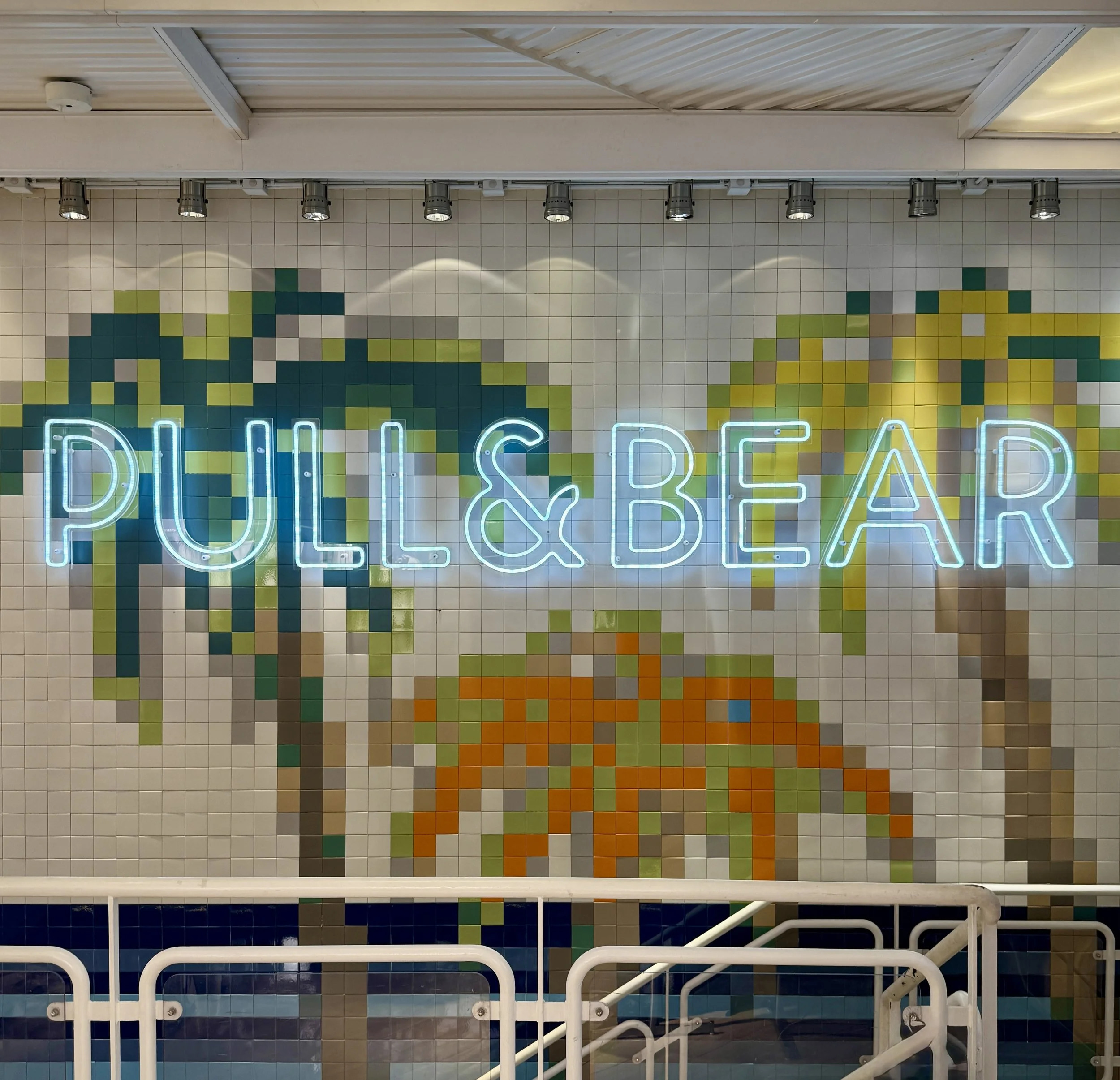 Neon sign and palm tree tilework at the Pull & Bear store in Lisbon, Portugal