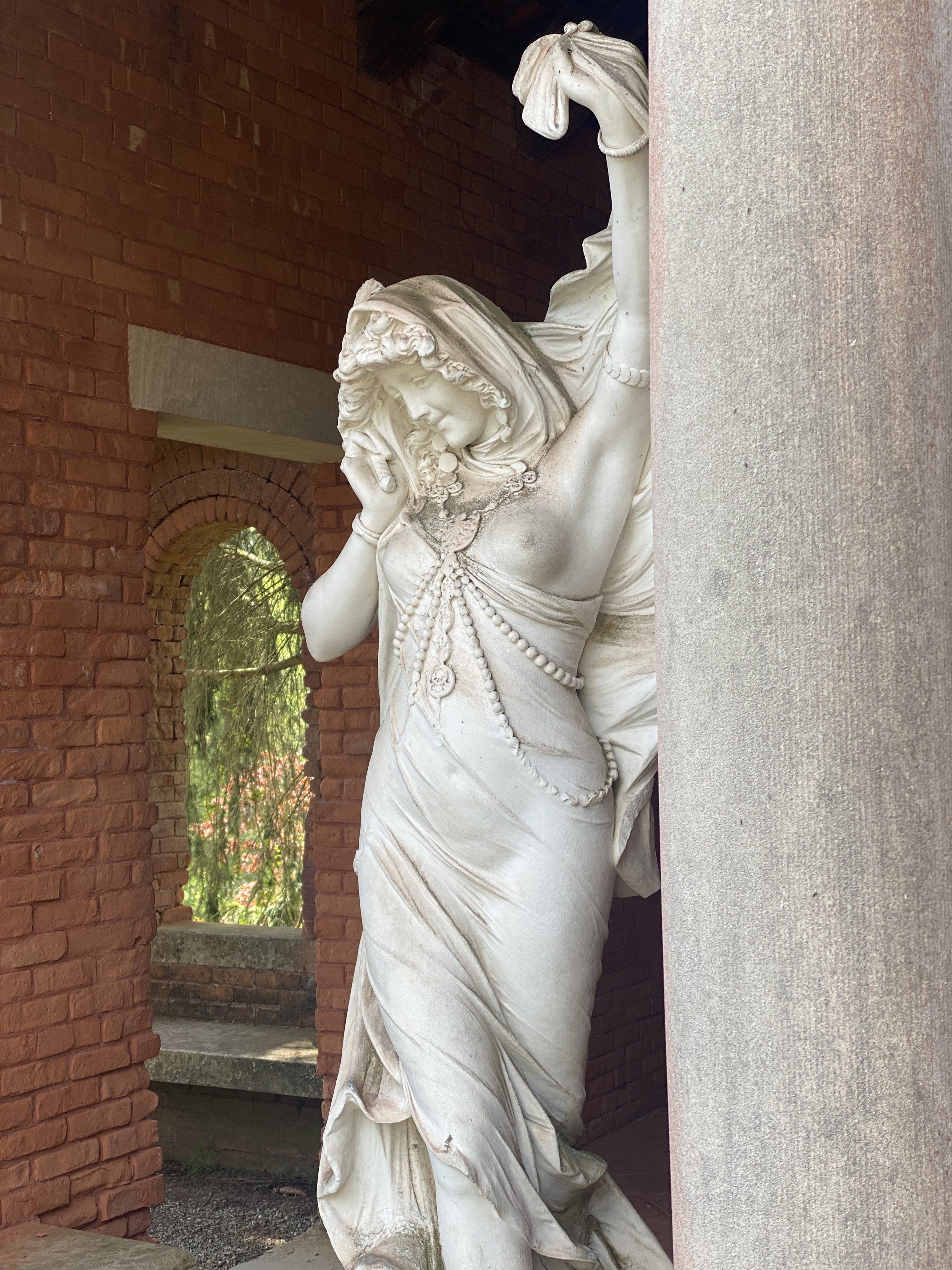 Statue of harem dancer with one breast out in the loggia at Vanderbilt Mansion