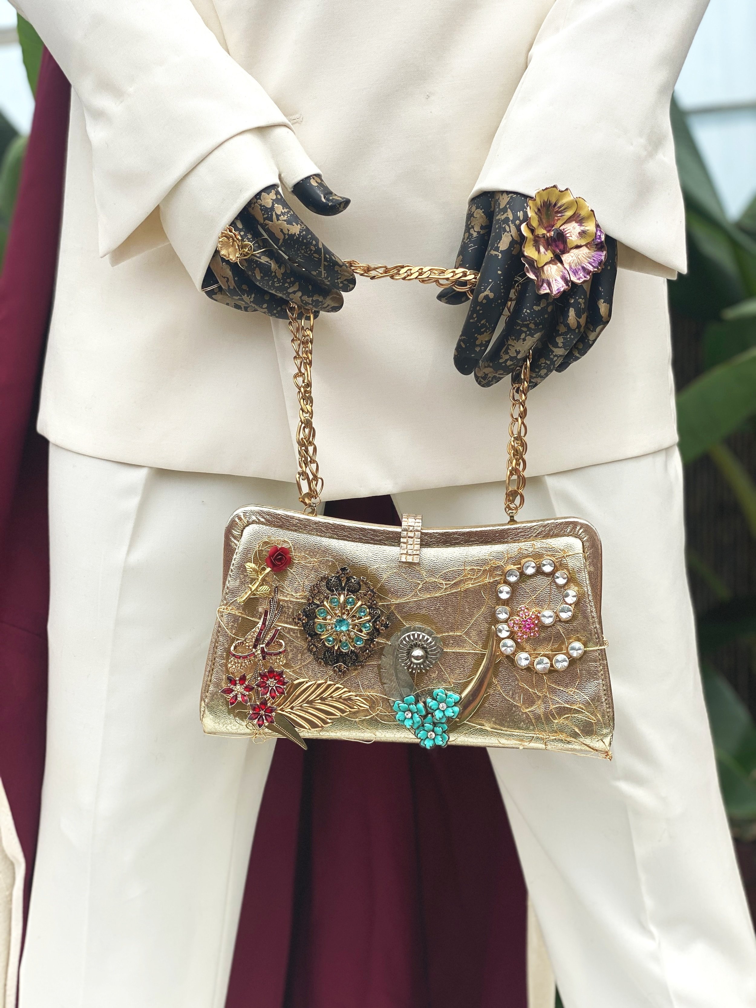 Mannequin wearing funky white suit with metal accents at the Phipps