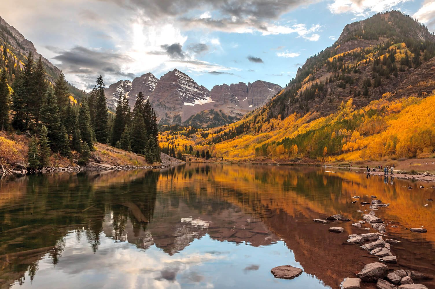 A lake in Aspen in the fall, with the trees a golden yellow
