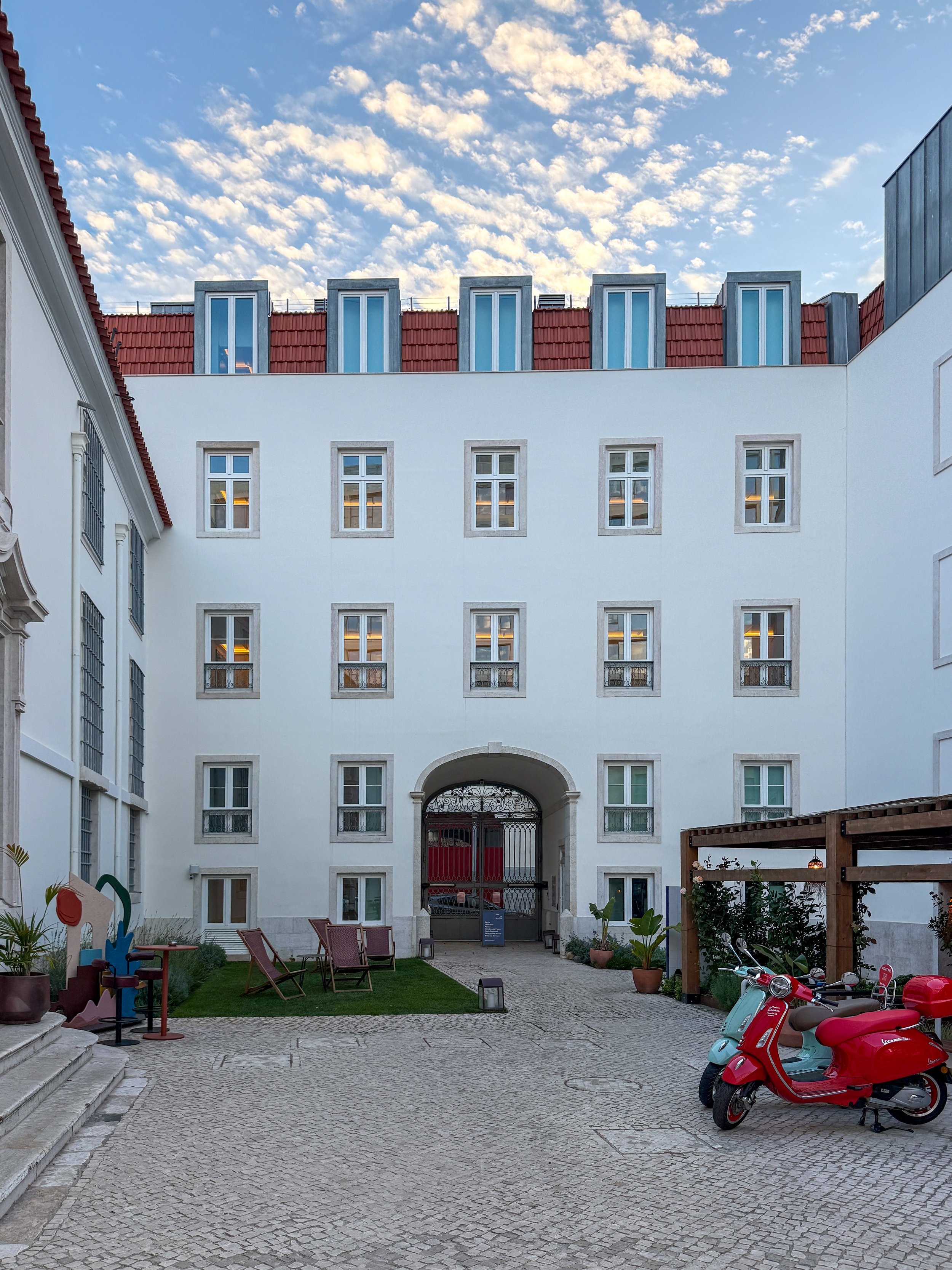 The Santa Marta wing of Locke de Santa Joana in Lisbon, with two Vespa parked in the courtyard