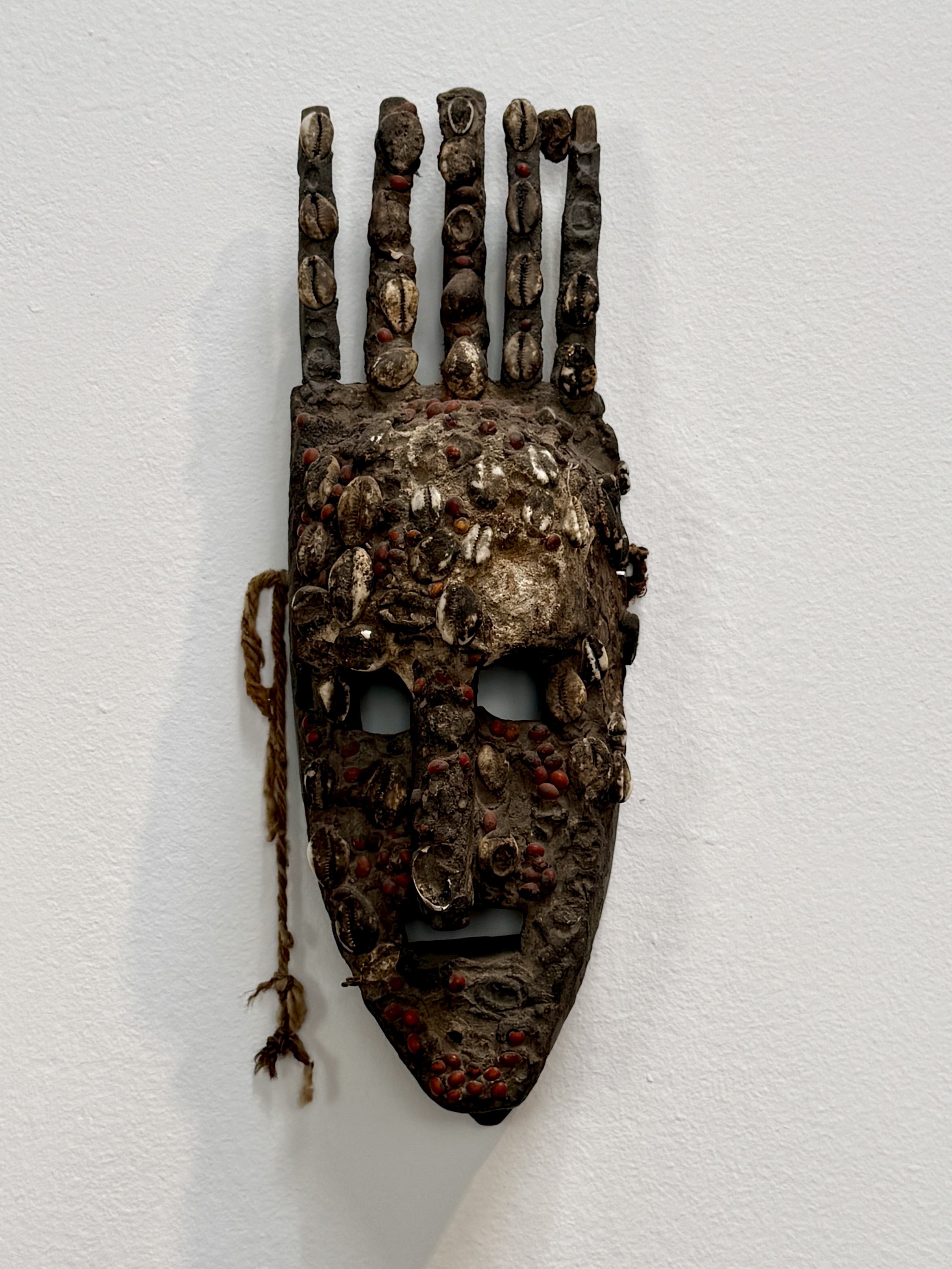 An Ndomo mask from Mali made of wood, wax, shells and seeds in the Patti Birch section of Dar el Bacha, Marrakech, Morocco