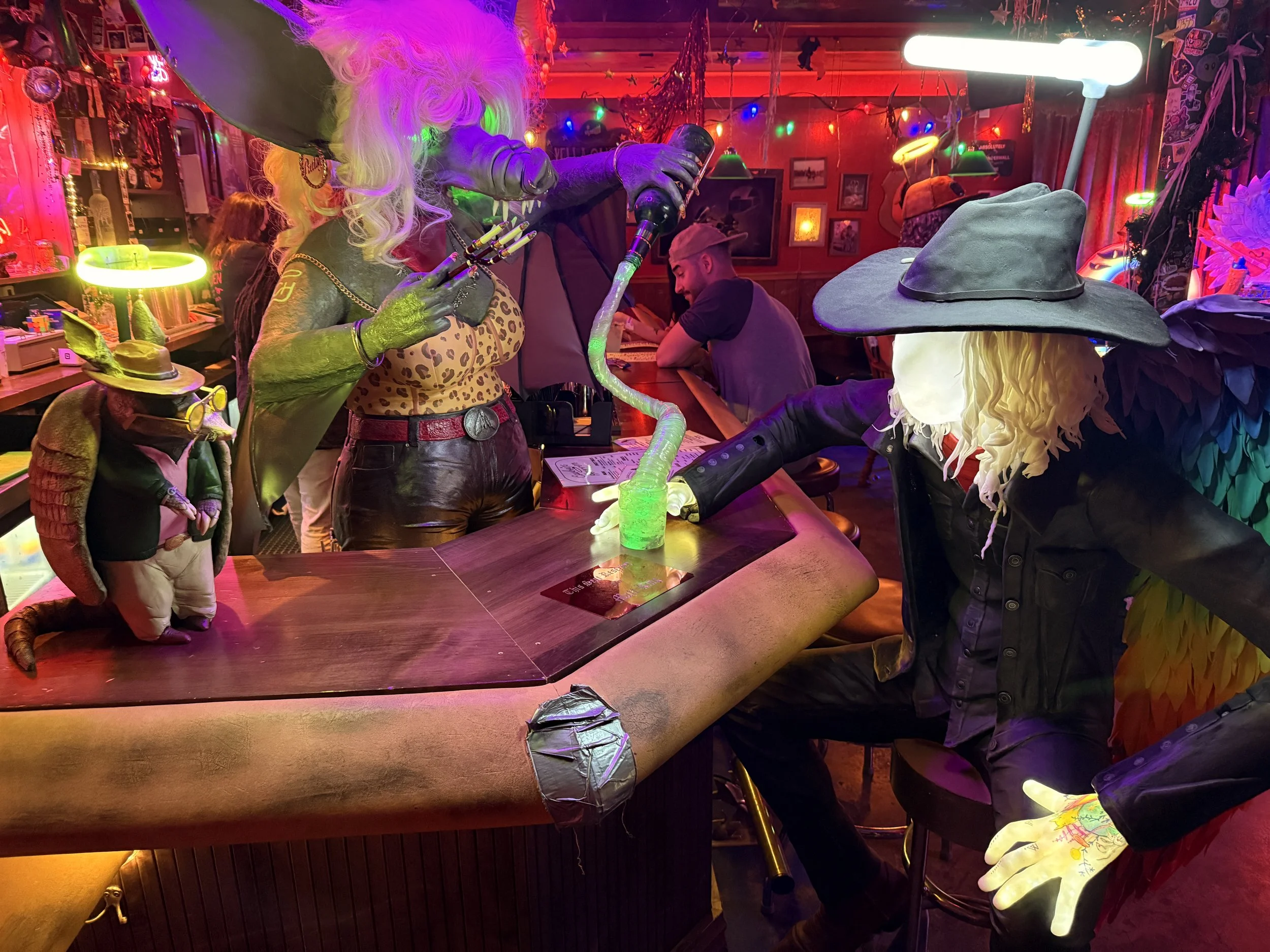 Bizarre alien mannequins at the bar at Cowboix Hevven at Meow Wolf Radio Tave in Houston, Texas
