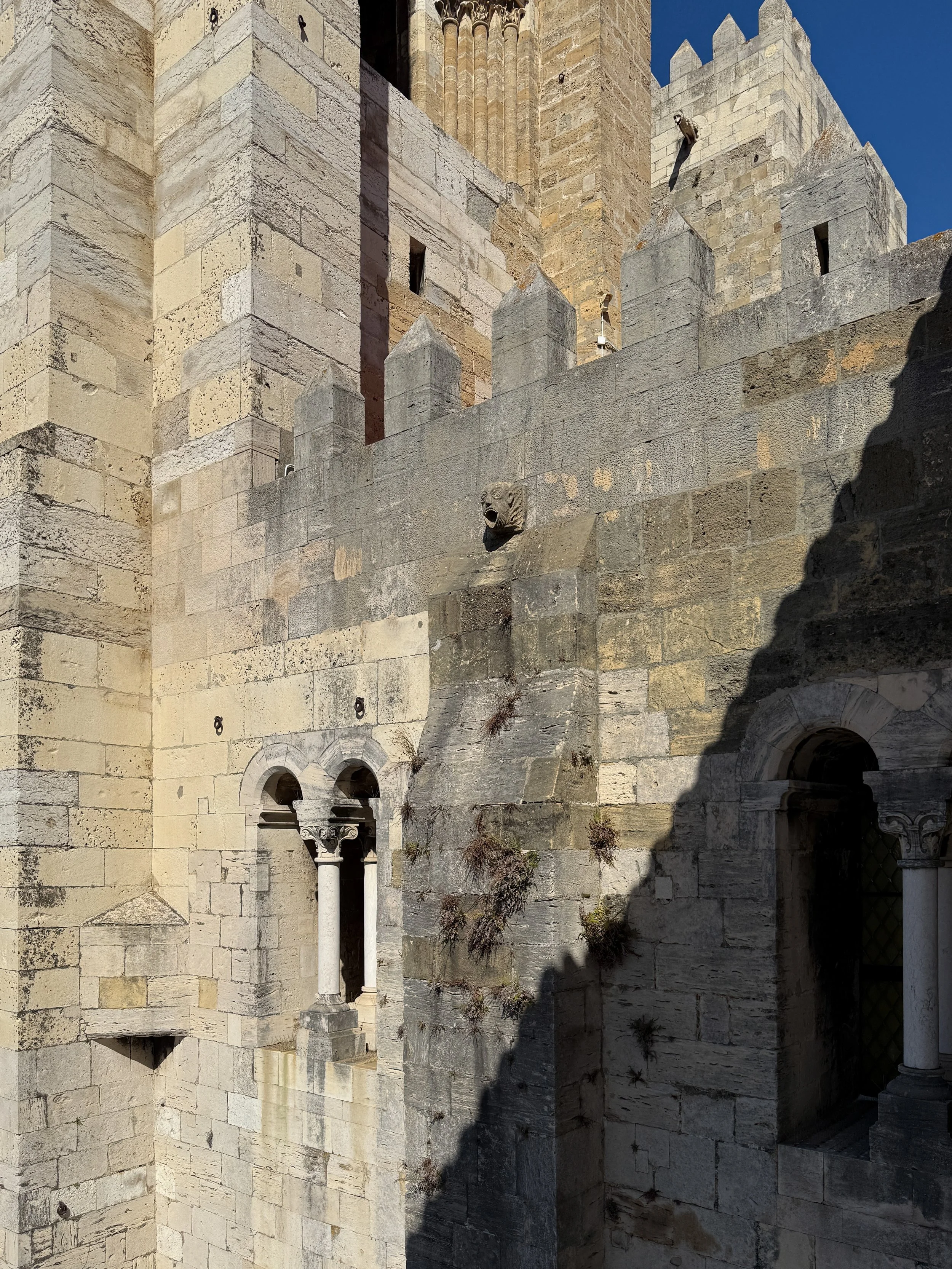 Jagged, tooth-like crenellations the Lisbon Cathedral’s Romanesque façade