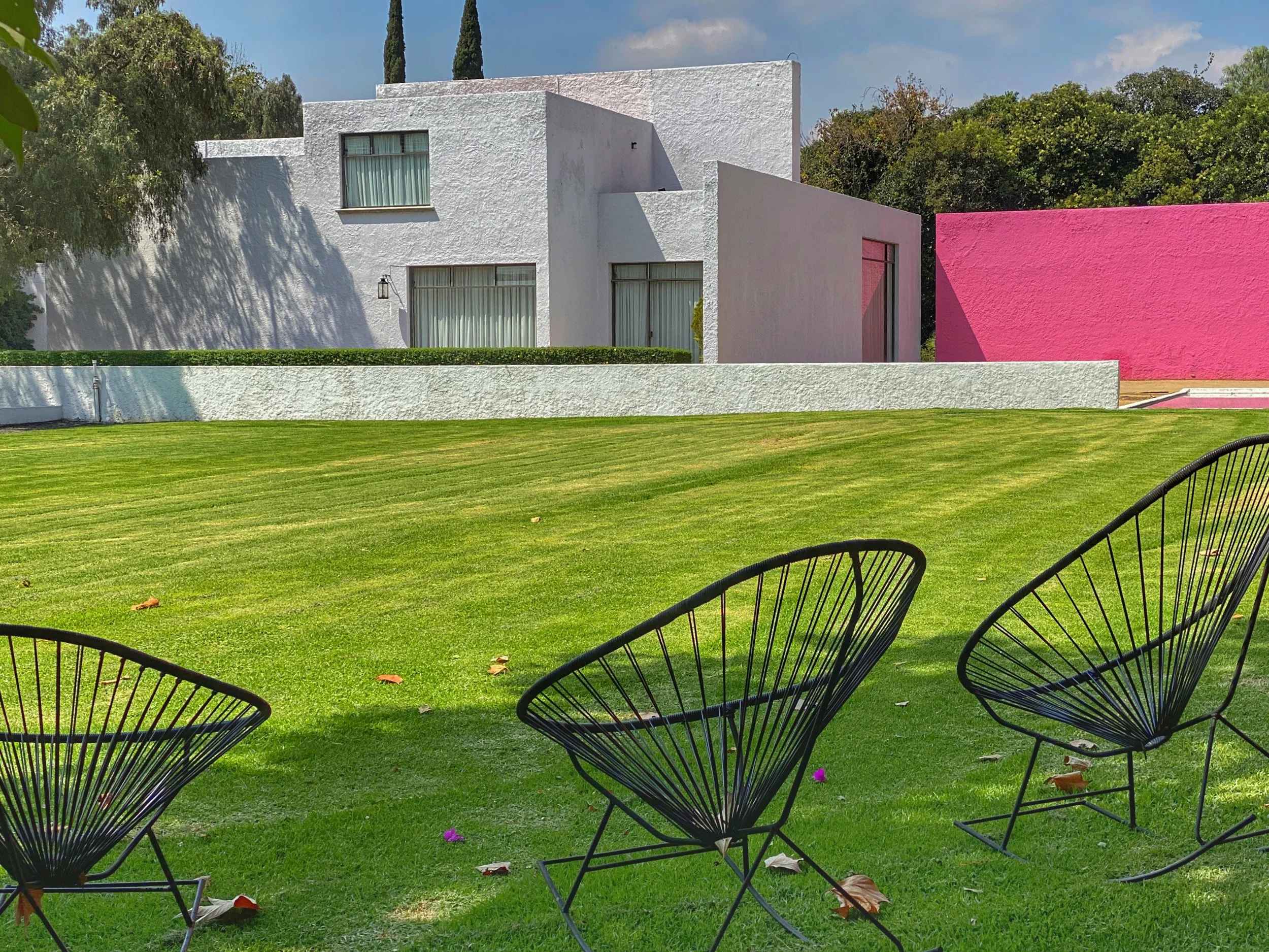 Metal chairs on lawn at Cuadra San Cristobal
