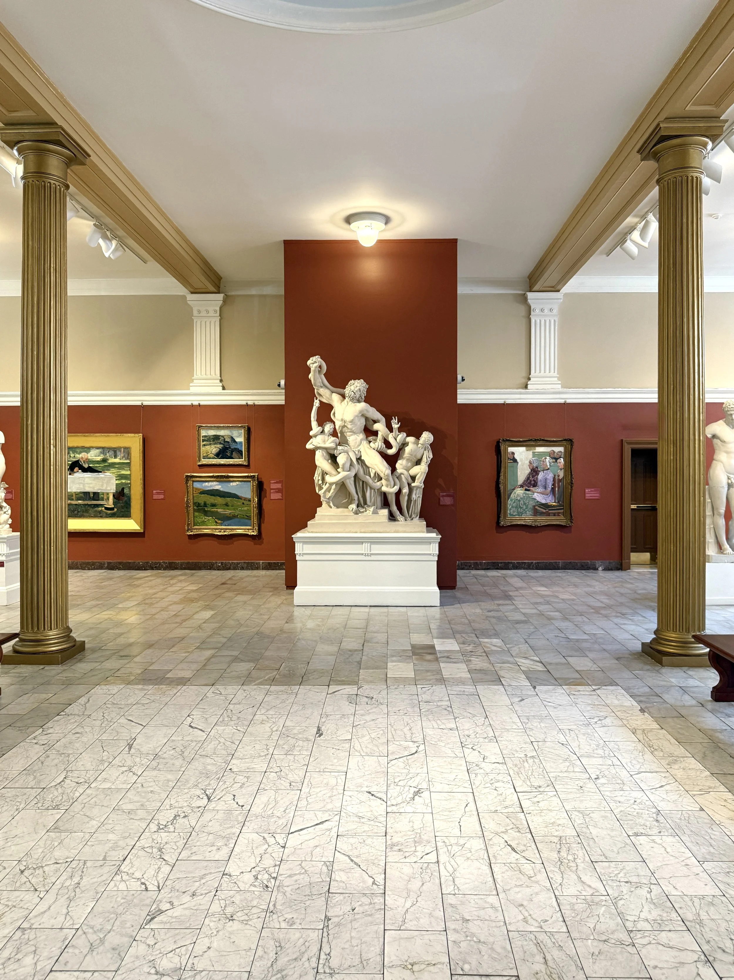 The Sculpture Gallery at the Telfair Academy in Savannah, Georgia, with a lighter section of the floor where a fountain once stood, and a statute of Laocoön and His Sons against the wall