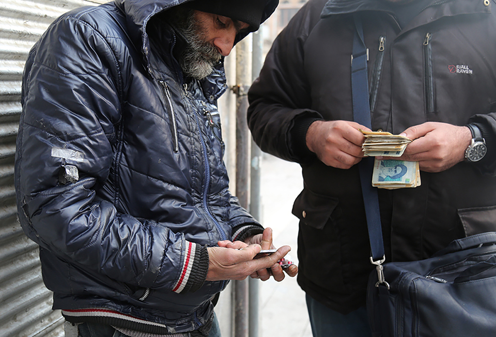 A black market medicine peddler sells foreign drugs on Anvari Street in Shiraz. Photo by Mohammad Mehdipour