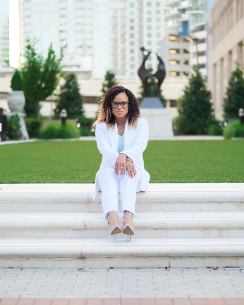 Charlotte outdoor headshot of a professional woman in white seated on urban park steps by mjwphoto