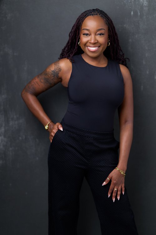 Professional studio headshot by a Charlotte headshot photographer, black backdrop, confident natural smile