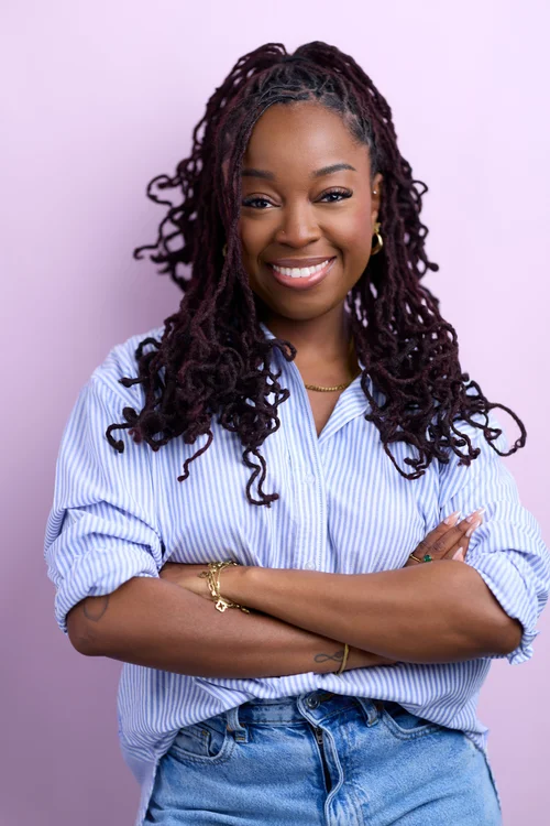 Approachable professional portrait on lavender backdrop from a Charlotte personal branding session