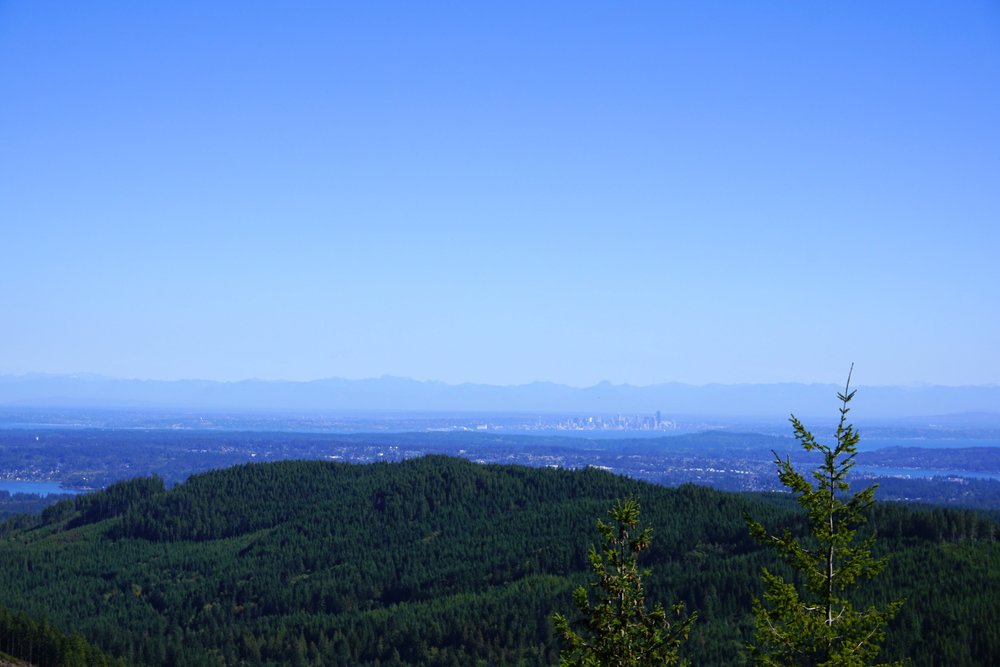 Distant views of Seattle and the Cascade Mountains from Green Mountain