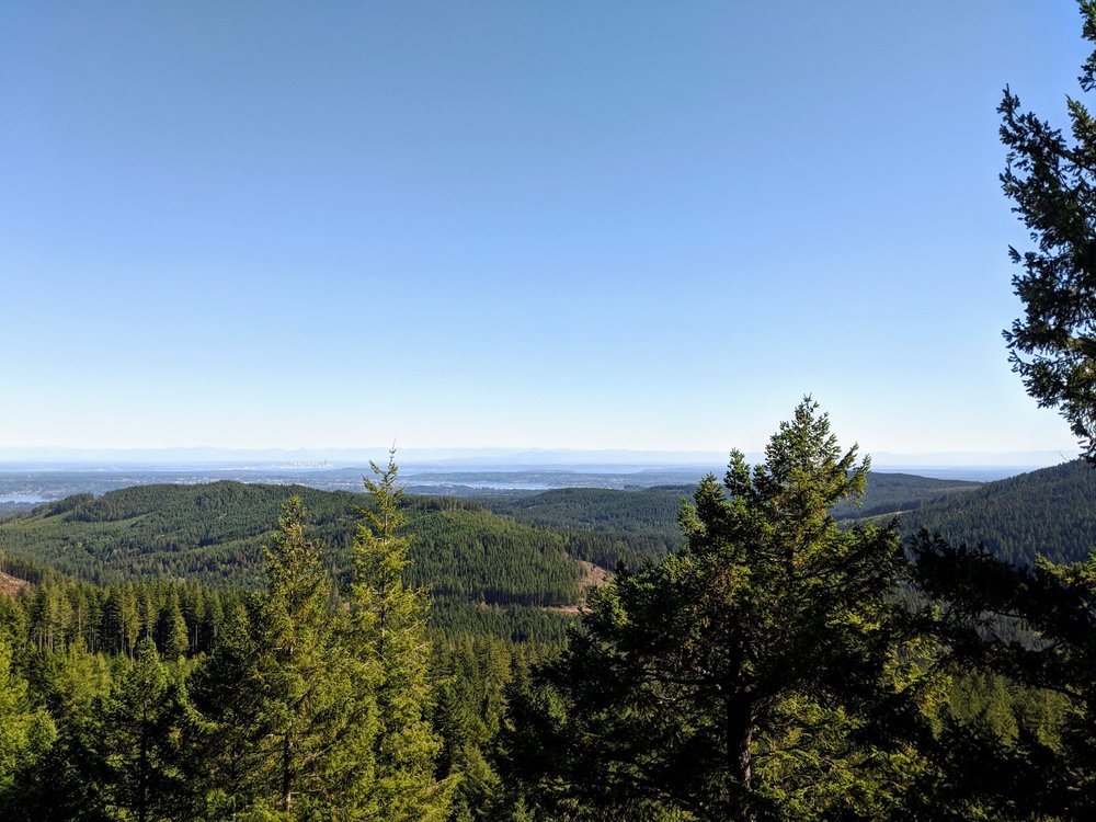 Distant views of Seattle and the Cascade Mountains from Green Mountain