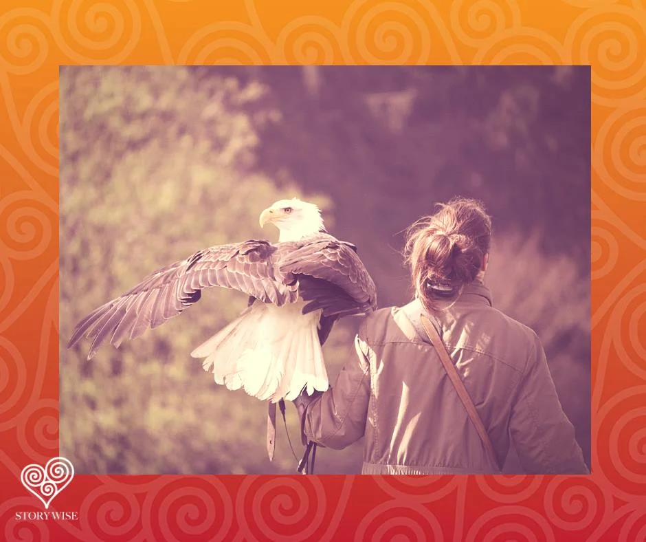  woman walking away with eagle on forearm 