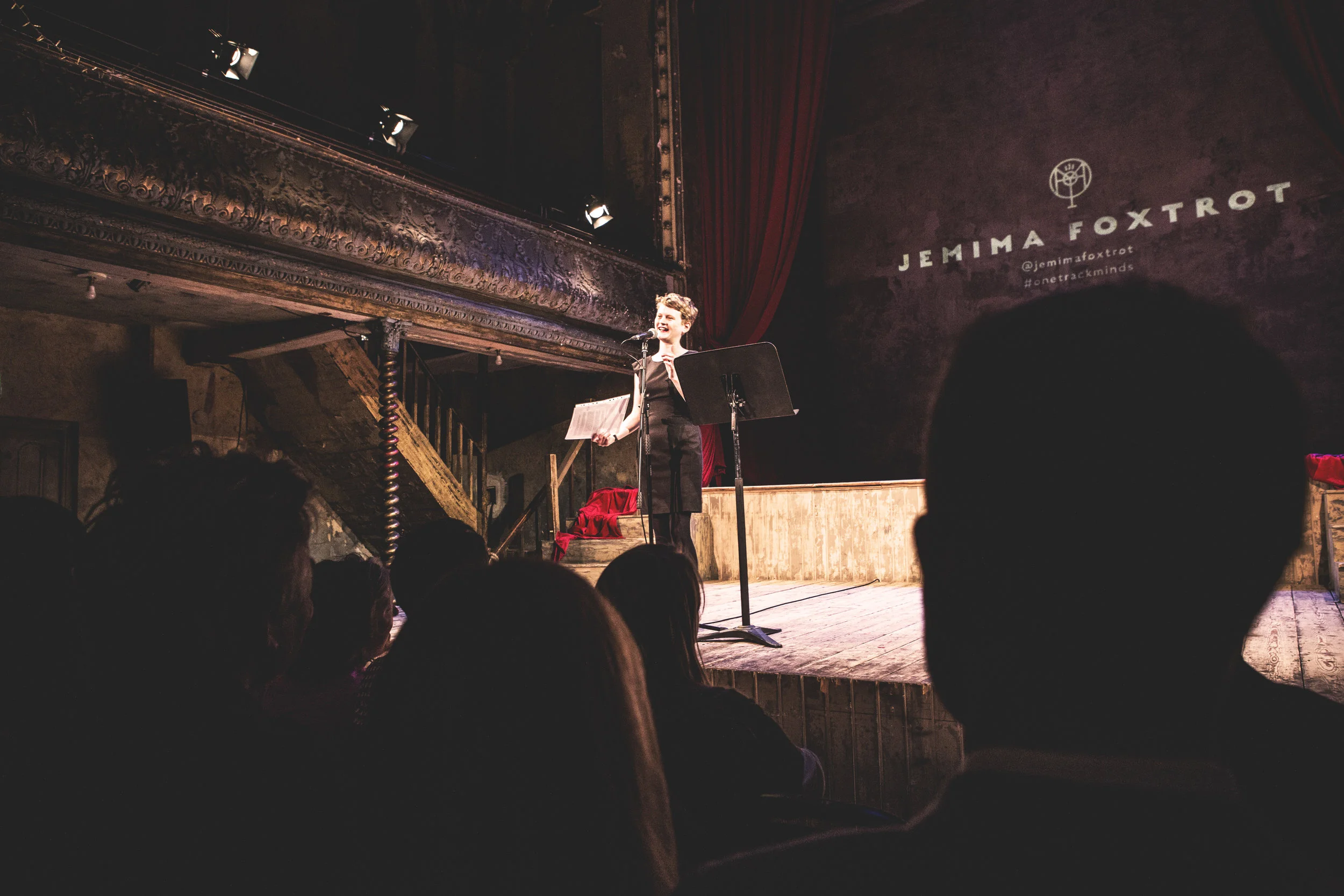 Jemima Foxtrot at Wilton's Music Hall, May 19th 2016 In episode 2 of our podcast, performance poet and singer Jemima Foxtrot tells a story about growing up in Hebden Bridge, and falling in with a crowd of friends who introduced her to the joys of Funk and Soul. Here's a transcription of her story: Hello. I'm a bit out of my comfort zone here because I usually do poems, and I've usually remembered them as well, and I haven't remembered this. So... I'm absolutely honoured to be here, I love this place. It's the first time I've ever been on this stage, and it's just really good, so thanks for having me. So... this is a story about growing up in Yorkshire, where I'm from; being a teenager, and music really. I was just 14 and I'd met a couple of lads. We were in Year 10 then, so were about yeah, 14, and we decided to make music together. There was a music room at school, sort of annexed at the back of the dining hall, and we were allowed to use it at lunch times. And we went there every, single, lunchtime. I had a tape of FRANK by Amy Winehouse, and I also had a Greatest Hits of Ella Fitzgerald tape that I found in a charity shop, and I'd listen to it over and over and over again. And when the boys weren't around, when they'd gone to smoke weed or whatever, I would stay in the music room, rewinding it over and over again, and practising the scats... SCATS You might say that copying scats kind of defeats the points of scat. But I did it an awful lot any way. So it was me, Jimmy and Louis at first, and we were playing covers. Quite a lot of shit covers like Elton John, which I hated. "My gift is my song"... we did that one. Louis was responsible for the cheese. We were going it back then, and we were madly in love in that way that is very specific to children. But he's remained a hefty romantic and he's now got two children. I was drifting towards a sort of howling sort of music, because I was really in awe of my own voice really loud voice. So I used to like singing stuff like. SINGS 'I just wanna make love to you...' and 'Wap ba ba loop bop a wop bam boo' So we were doing all of that sort of stuff, which was v. enjoyable. And we ran into this guy called Callum. Now I knew Callum a bit from the woodcraft folk. I'm from Hebden Bridge - and that's classic Hebden Bridge - I was in the woodcraft folk. And he was in the junior brass band, and we used to laugh at them every Christmas Eve when they used to play carols in the town square in their stupid little suits. But also, and much more importantly, he played trombone and sax in this Ska band, in which he was the baby; and he was the year above us, and so that was very exciting. Rehearsals moved to Louis's parents' front room. We had two guitars, one voice and a trombone, and we were so chuffed with ourselves. I was particularly happy with the brass. So far in my little experience, I had mainly been into music that was pushed on me by my Dad and I do love it still - Leadbelly, Woody Guthrie, The Rolling Stones and of course Bob Dylan. Years later, I wrote my English Literature dissertation on Dylan which cemented my love for poetry and music and my fascination between the blurred lines between the two. So anyway, we needed a drummer. And as some of you may know, good drummers are notoriously hard to find. We sloped around in our weird acoustic brass outfit for a while doing Village Open Mics, pubs and the like. Eventually, Callum said there was this girl in his year, who had a little brother who played the drums. How little? The kid was two school years below us - I think he was 12 years old at the time. We were very, very skeptical, naturally. We all lived in and around Hebden Bridge in the Pennines, as I said. It's beautiful there - steep sided valleys, dark trees - of course, we didn't really appreciate it back then, all that sort of gasping frantic landscape. And when I go back now, it's just amazing. You should definitely try and go. So the new potential drummer lived halfway up the really steep hill that went to my house. So we traipsed up there one Wednesday night and we shuffled in. And his parents were all proud and polite, and showed us in and offered us tea. And we went down to the basement where Joe's basic three piece turquoise drumkit was. And I was thinking 'fucking hell'. Anyway, I'm sure you know what happens next. He FUCKING INCREDIBLE. Oh my God. I'd never seen anything like it. I was blown away. So he was in. And we started going up there regularly to practice, and of course we became really good friends. As you'll have noticed by now, Joe was not your ordinary twelve-year-old. Now I'm going to credit Joe Ackroyd to introducing me - properly introducing me - to the genres that have played a really influential role in my work and in my development as an artist. And the genres that I dance to, to this day, in my bedroom, in clubs, on the streets. The genres I like to attach myself to, and that validate me as a happy and optimistic person. Funk and Soul. An ex once said to me that he couldn't listen to a single Funk and Soul song with a female vocal without thinking of me bouncing up and down on a head, dancing, grinning from ear to ear. It's the music that has made me sing "Oh what a good feeling to feel like I feel. I say oh, what a good feeling to feel like I feel. I say oh, what a good, oh what a good, oh what a good feeling to feel like I feel." It's the music that's made me sing - "Hey, I'm a good woman. I'm a good woman. Such a good woman. So don't treat me like dirt". So it was my eighteenth birthday. We were still in the band by then, four years on. Joe made me a mix CD that he called 'Funk Salad'. He's a bit of a sarcastic and pun-centred guy. It had a big mix of songs on that I would play over and over and love forever. It was all no-nonsense, deep and ravenous female lead singers and so much all-consuming groove. I still have the CD - it moved to Manchester, and then down here to London with me. The band went on to expand - we gained a bassist, James - and we went on to win five days recording time as the prize for coming first in the local 'Battle of the Bands'. We moved on from covers, and, at the risk of blowing our own trumpets, wrote some pretty good pop songs. James and Callum left eventually, so it just became me, Jimmy, Joe and Louis, and on we went. Pretty early on in the band's career, when we were still doing covers, Joe suggested we do this song. With the most joyful, yearning lyrics. But not only this song - but this specific version of this song. I absolutely fucking loved it. We took it on. I remember finding it hard to do the new version of the vocal on the chorus - I suppose the old one was just so ingrained. I remember saying I just, couldn't, do it! and Joe going, "No! Come On! You can - you HAVE to". When the track plays you'll notice it starts with a very distinctive drumbeat. Whenever I hear that drumbeat play, I remember Joe, the band... being a teenager in that valley, and soaking up and belting out all that music. This song showed me that you can take other people's music and make it your own. It showed me the wonder and creativity of the cover version. I saw Joe, Jimmy and Louis again just last month for not such a happy occasion - a funeral. Our friend Jed died in April, aged 25. It was a glorious day the funeral though - a glorious Yorkshire day. Hot and sunny - I got sunburned really badly whilst drinking outside the pub by the canal. And being with those boys again made me so proud of what we achieved in my time growing up there. Joe lives in Hebden Bridge still, having spent stints in Manchester, but he absolutely monopolises the music scene there. I think he's in about seven bands - and it's only got a population of about ten thousand, so that's pretty good! He's an incredible musician, and now a DJ as well, and he's grown into a man from that 12-year-old with a fantastic talent, and probably the best taste in music that I know. And I feel such a bond to them. The boys in the band. I don't have many friends left from school, but they remain. And I think they always will. And I'm eternally grateful to Joe, for introducing me to a whole world of music through this song, that has buoyed me up and influenced, not just my work as a poet, but my attitude towards the whole world. So thanks for listening. Thanks to Joe and to the band. And please sit back and enjoy Spanky Wilson with her wonderful cover of Sunshine of Your Love... 