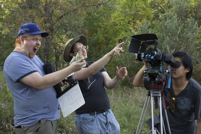 A typical representation of a film set. Producer: "AHH MONEY!" Director: "You see this is my vision." Cinematographer: "Check out this shot folks."