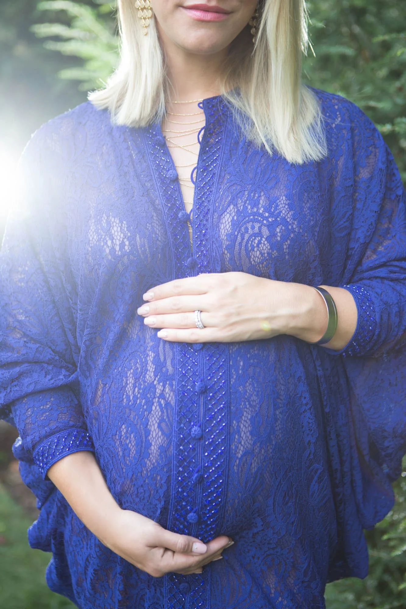 expecting detail of belly with blue lace dress