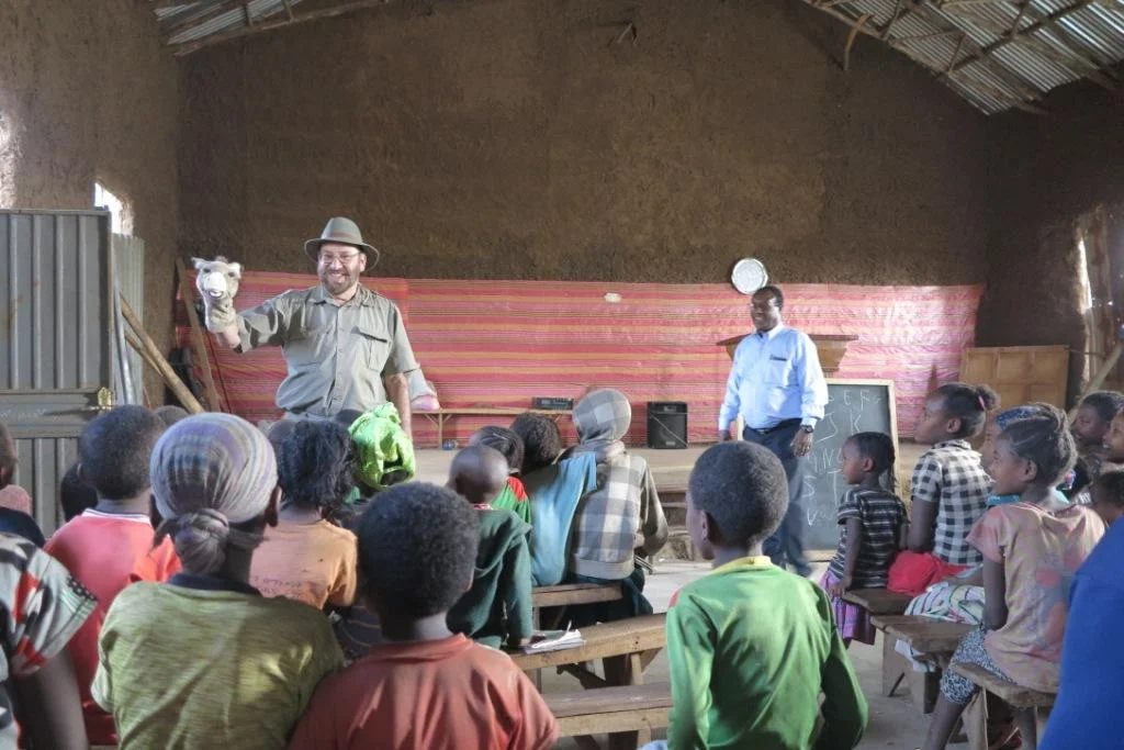  2018 visit to a proposed new school site called Korga, near Lake Awassa, Ethiopia. Peter's puppet show with a donkey! 