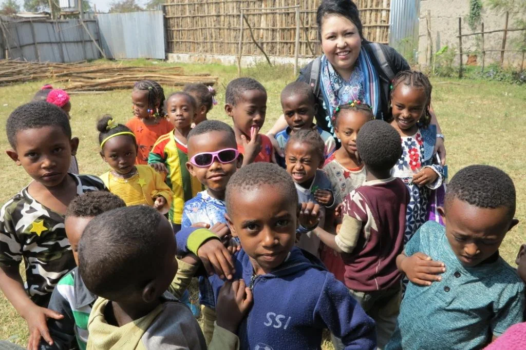  2018 Sharon Saenz with children at the proposed new school site in Bachobore, Jimma, Ethiopia. 