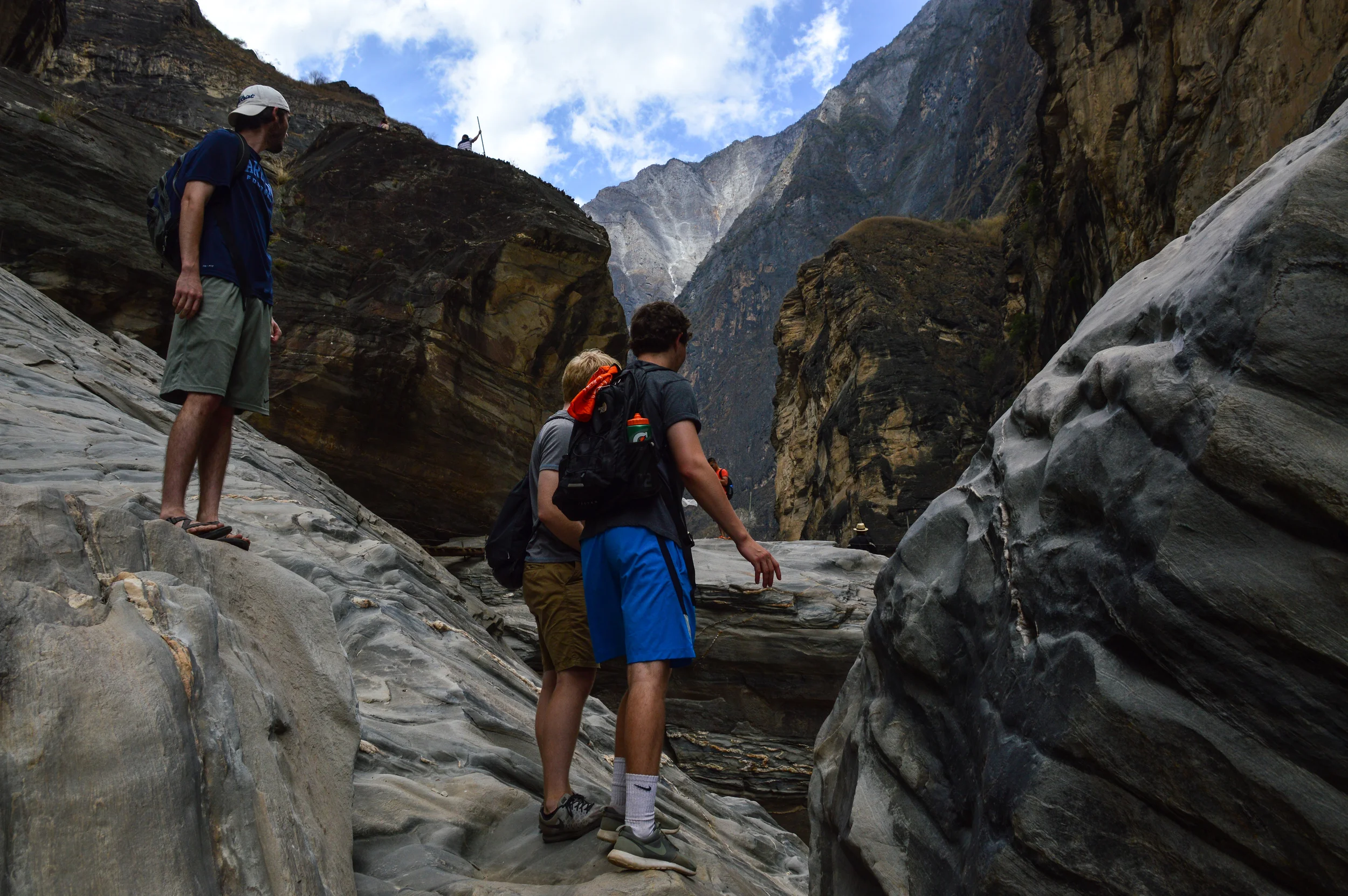 Yunnan Province, China - the core of the Tiger Leaping Gorge is surrounding by high mountains peaks just off the Himalayas. Zach Smith, Nathan Cooksey, and Thomas Darden watch their step to travel the rocks.
