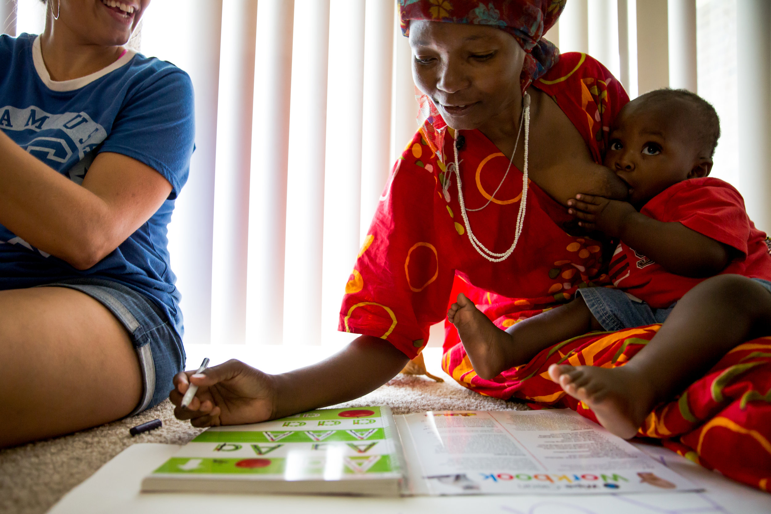 Mnoza was raised a farmer. She didn't go to school growing up in Somalia and, consequently, never learned the alphabet. Eugenia Wittick has weekly lessons with Mnoza to teach her the basics. Here she is learning the alphabet while breastfeeding her youngest child, Muhammad (also called Mudi).
