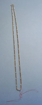 Center front of chain necklace marked with thread