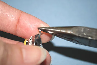 Turning jump ring with chain nose pliers