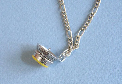 charm attached to necklace chain