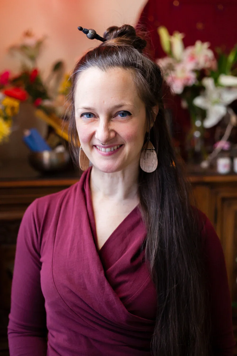 image of Damion bond, a white woman with long brown hair and blue eyes, wearing a maroon shirt