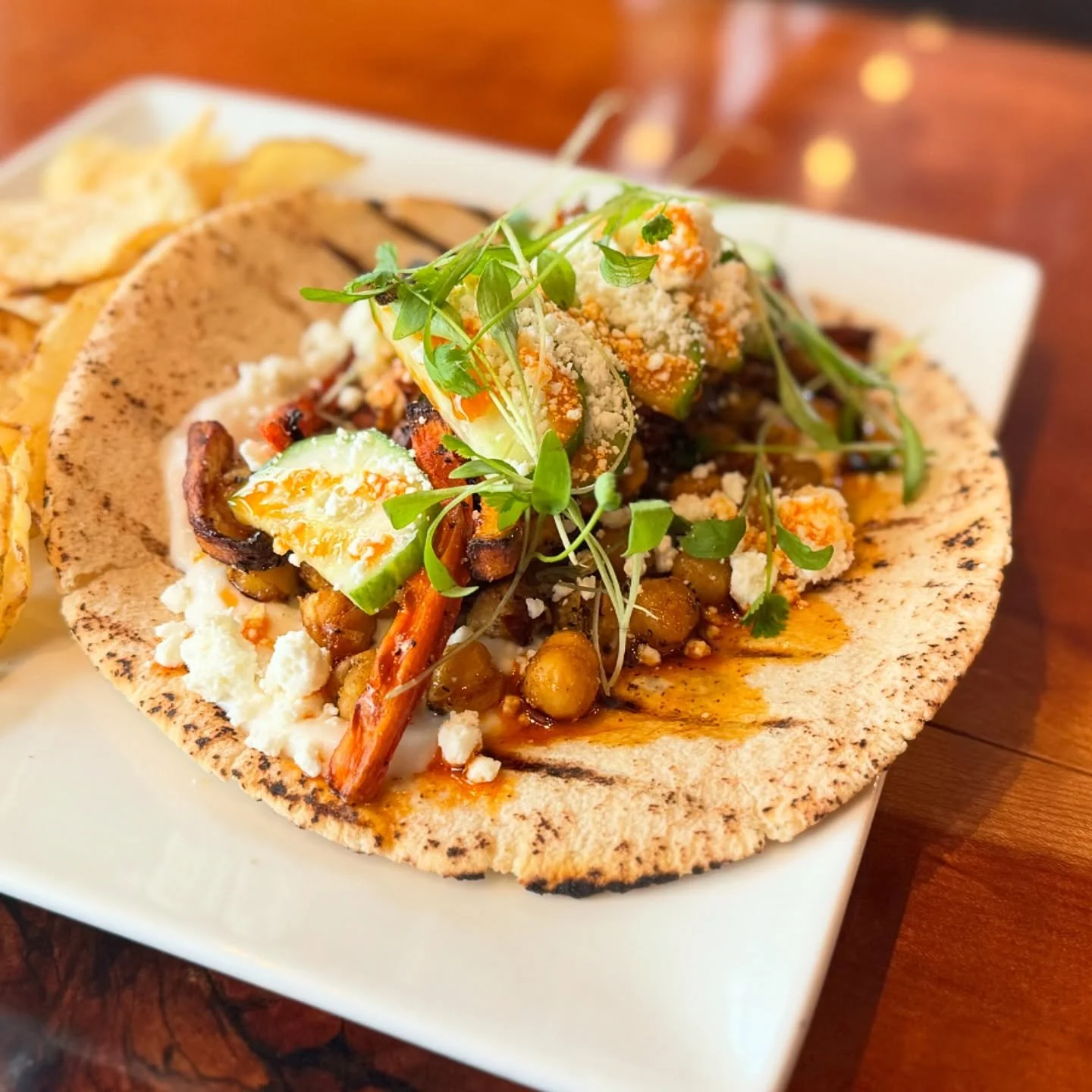 Full of flavor and I&rsquo;m obsessed! Pita is back - Omena organics masala chickpeas, charred carrots, toum sauce, micro cilantro, feta, add: shawarma chicken or organic tofu. @taproot_cider_house #ciderhouse #vegetarianfood #bestsandwich @mynorthme